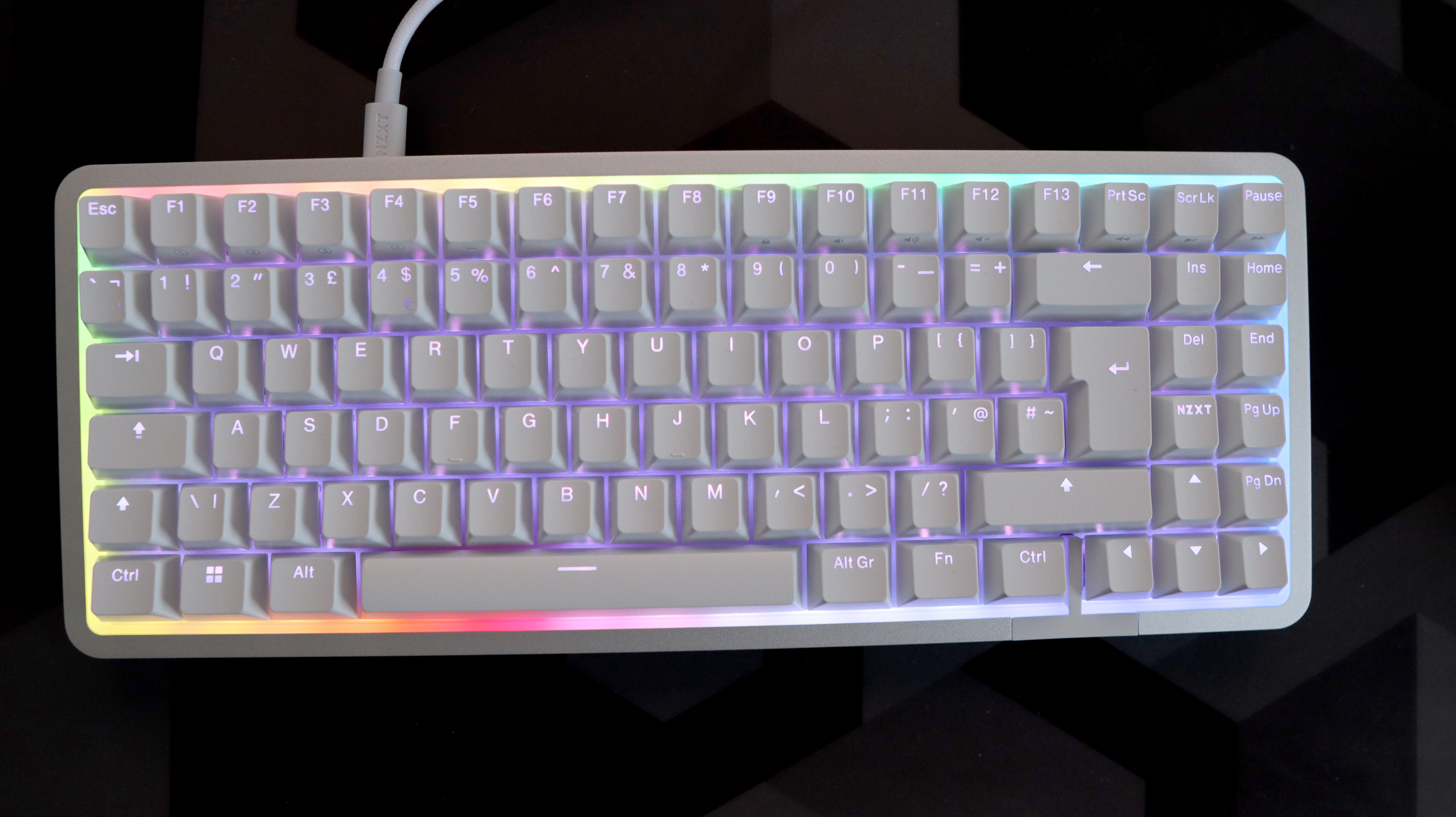 NZXT Function Elite MiniTKL with RGB lighting enabled on a desk.