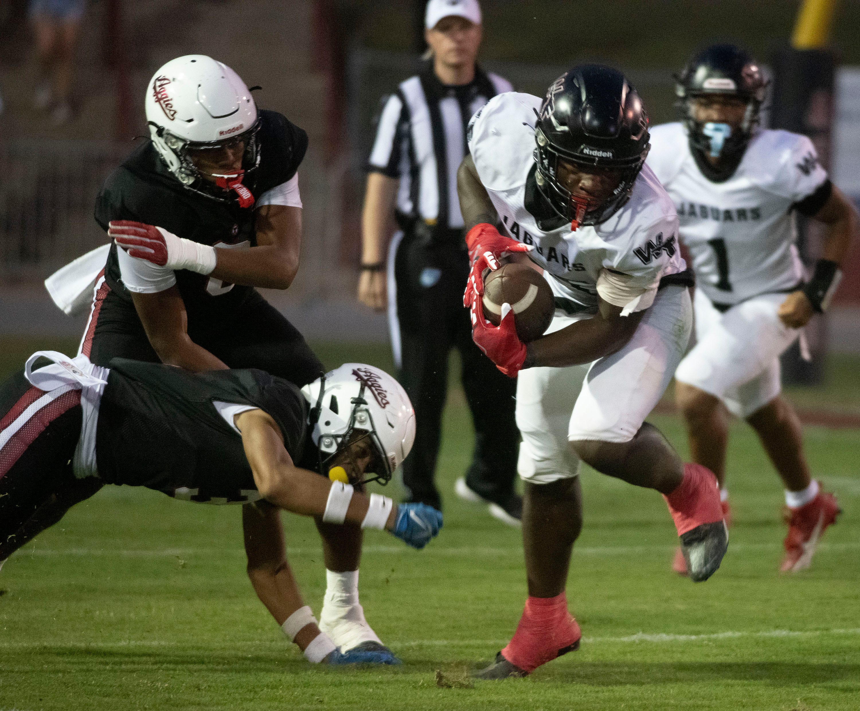 West Florida running back Charles Benson (No. 20) dances his way past the Tate defense for a significant gain during their Week 5 gridiron matchup.