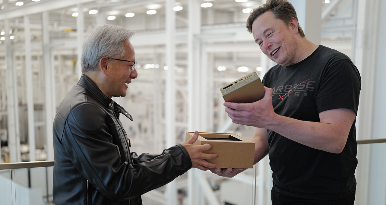 Nvidia CEO Jensen Huang handing Elon Musk the first DGX Spark mini supercomputer unit at SpaceX facility.