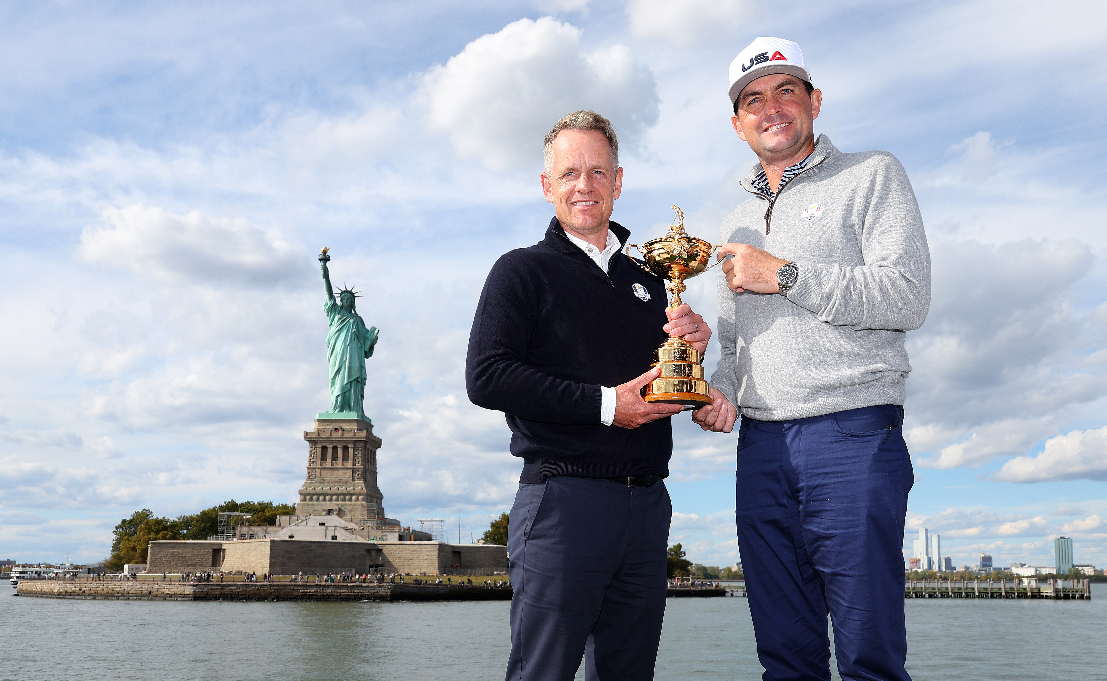 FARMINGDALE, NEW YORK - OCTOBER 08: Team Captains Luke Donald of England and Keegan Bradley of The United States pose for a photograph with the Ryder Cup Trophy during the Ryder Cup 2024 Year to Go Media Event at the Statue of Liberty on October 08, 2024 in New York, New York. (Photo by Andrew Redington/Getty Images)