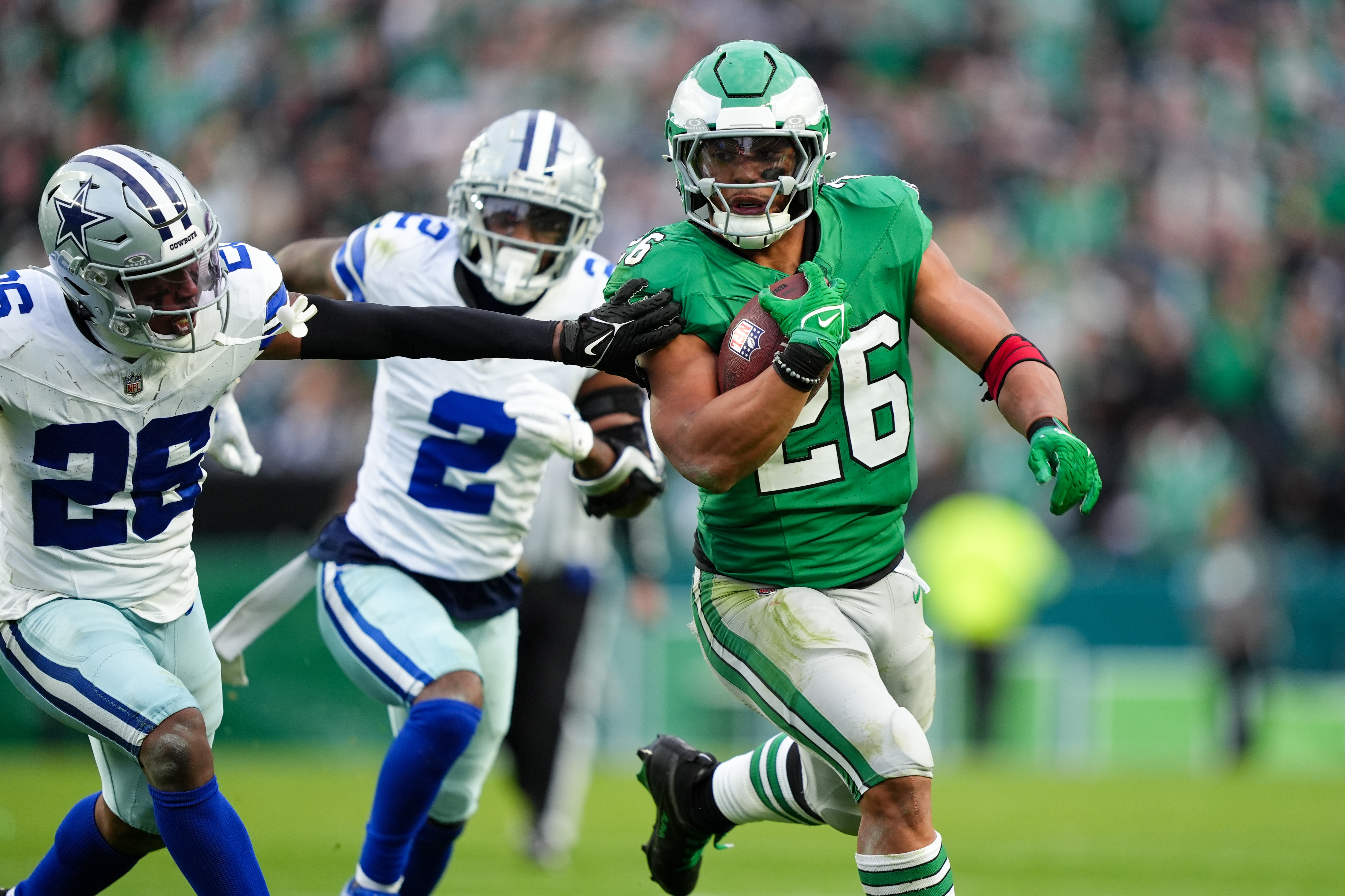 PHILADELPHIA, PA - DECEMBER 29: Philadelphia Eagles running back Saquon Barkley (26) carries the ball against Dallas Cowboys defensive back DaRon Bland (26) in the second half during the game between the Dallas Cowboys and Philadelphia Eagles on December 29, 2024 at Lincoln Financial Field in Philadelphia, PA. (Photo by Kyle Ross/Icon Sportswire via Getty Images)
