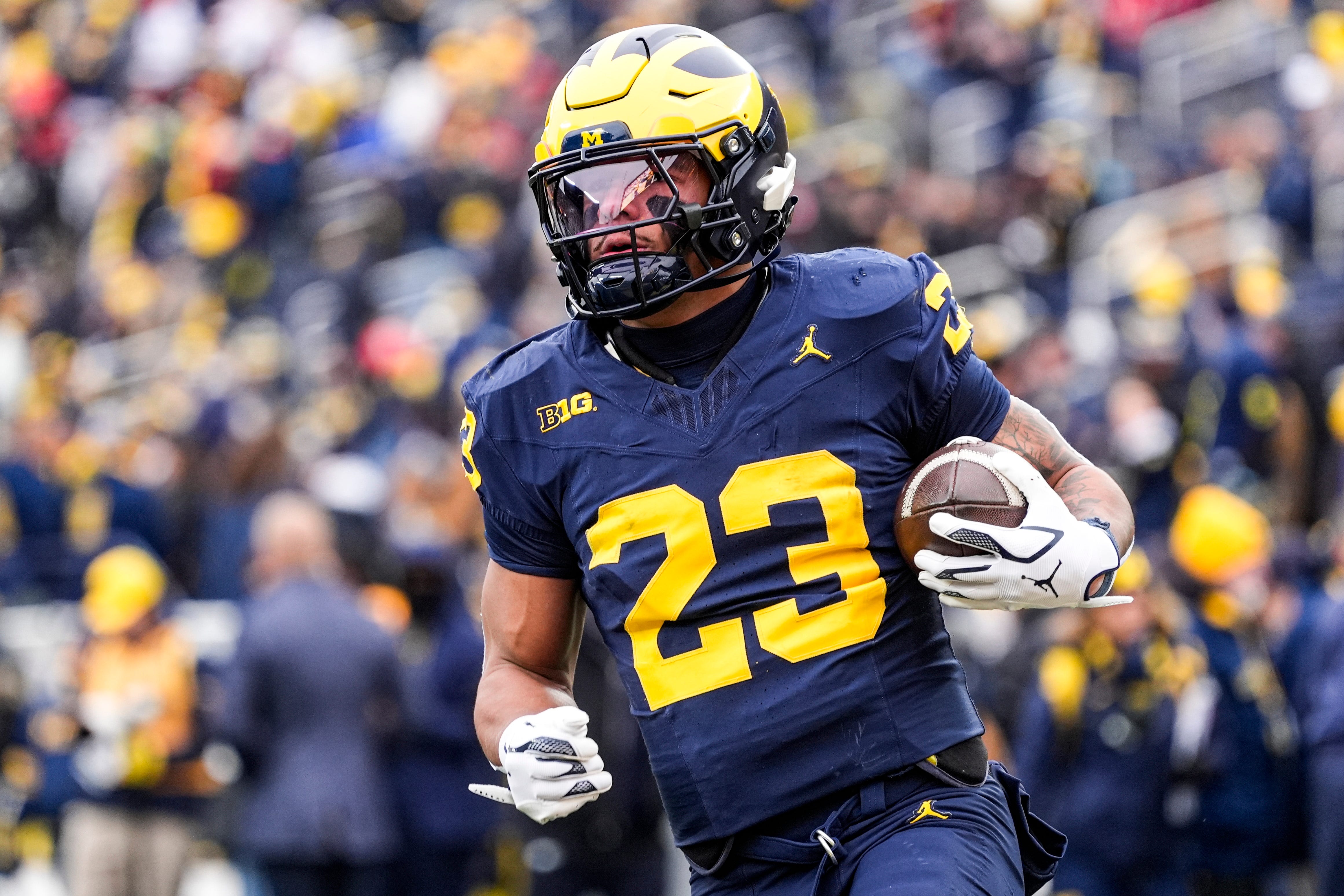 Michigan running back Jordan Marshall (23) warms up at Michigan Stadium in Ann Arbor on Saturday, Nov. 29, 2025.