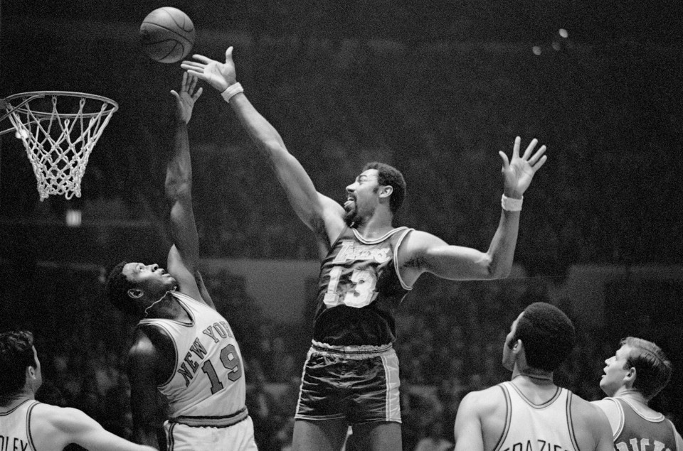 (Original Caption) Fingertips New York: Wilt Chamberlain (#13) of the Los Angeles Lakers and Willis Reed (#19) of the New York Knickerbockers go after a rebound during game at Madison Square Garden here Feb. 18th. Chamberlain scored 31 points to lead the Lakers to a 113-109 victory over the Knicks and crack the Knicks' 11-game winning streak.