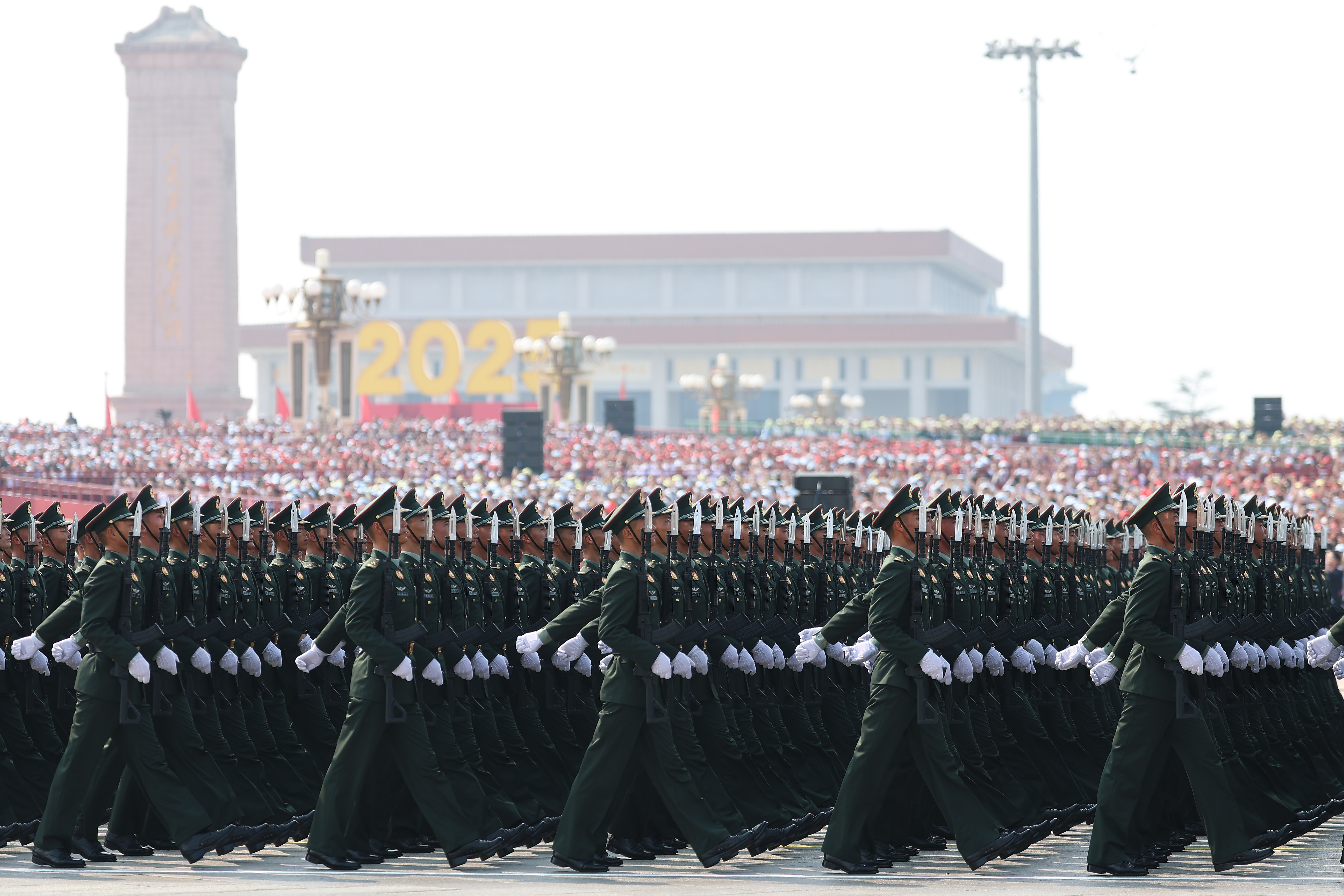 BEIJING, CHINA - SEPTEMBER 03: Soldiers march during a military parade marking the 80th anniversary of victory over Japan and the end of World War II, in Tiananmen Square on September 03, 2025, in Beijing, China. China's Victory Day military parade serves as a powerful display of national pride and military power. This year's parade carries heightened geopolitical weight with the attendance of leaders like Vladimir Putin, Kim Jong Un and Narendra Modi, underlining China's diplomatic alliances as it presents itself as an alternative global leader. (Photo by Lintao Zhang/Getty Images)