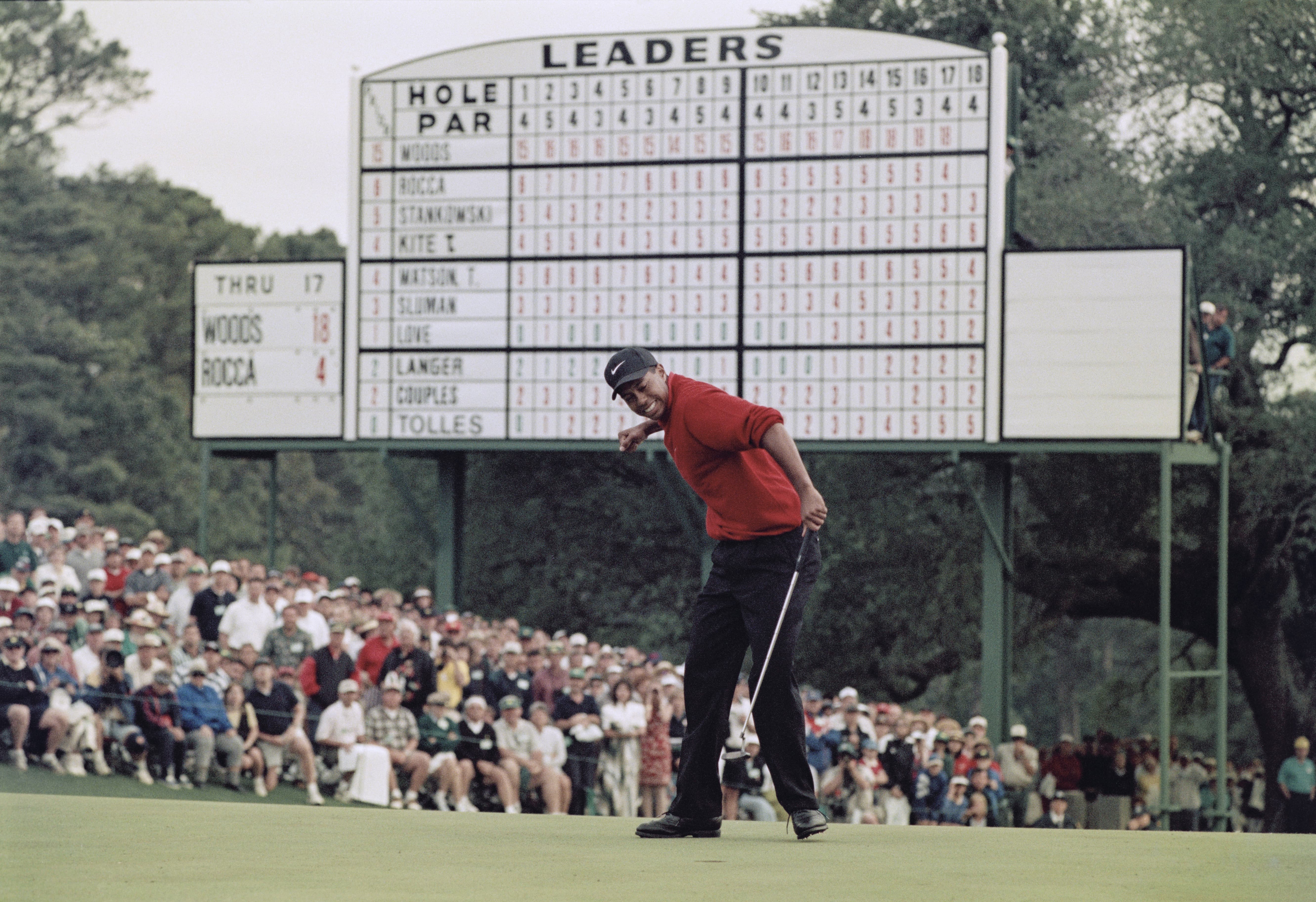 Tiger Woods of the United States celebrates after sinking a 4 feet putt to win the US Masters Golf Tournament with a record low score of 18 under par 13 April 1997 at the Augusta National Golf Club in Augusta, Georgia, United States.