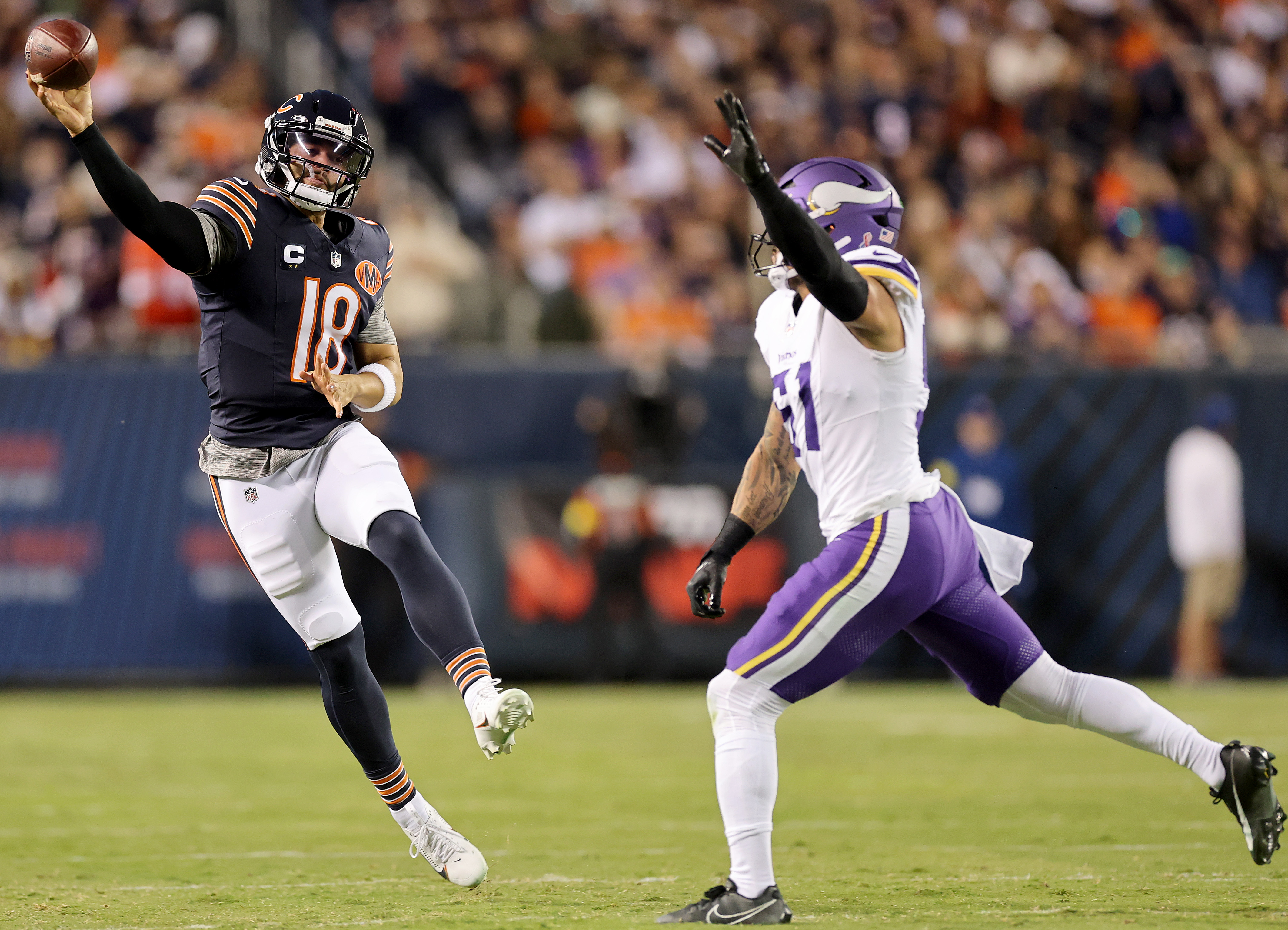 CHICAGO, ILLINOIS - SEPTEMBER 08: Caleb Williams #18 of the Chicago Bears throws the ball while under pressure from Blake Cashman #51 of the Minnesota Vikings in the game at Soldier Field on September 08, 2025 in Chicago, Illinois. (Photo by Michael Reaves/Getty Images)
