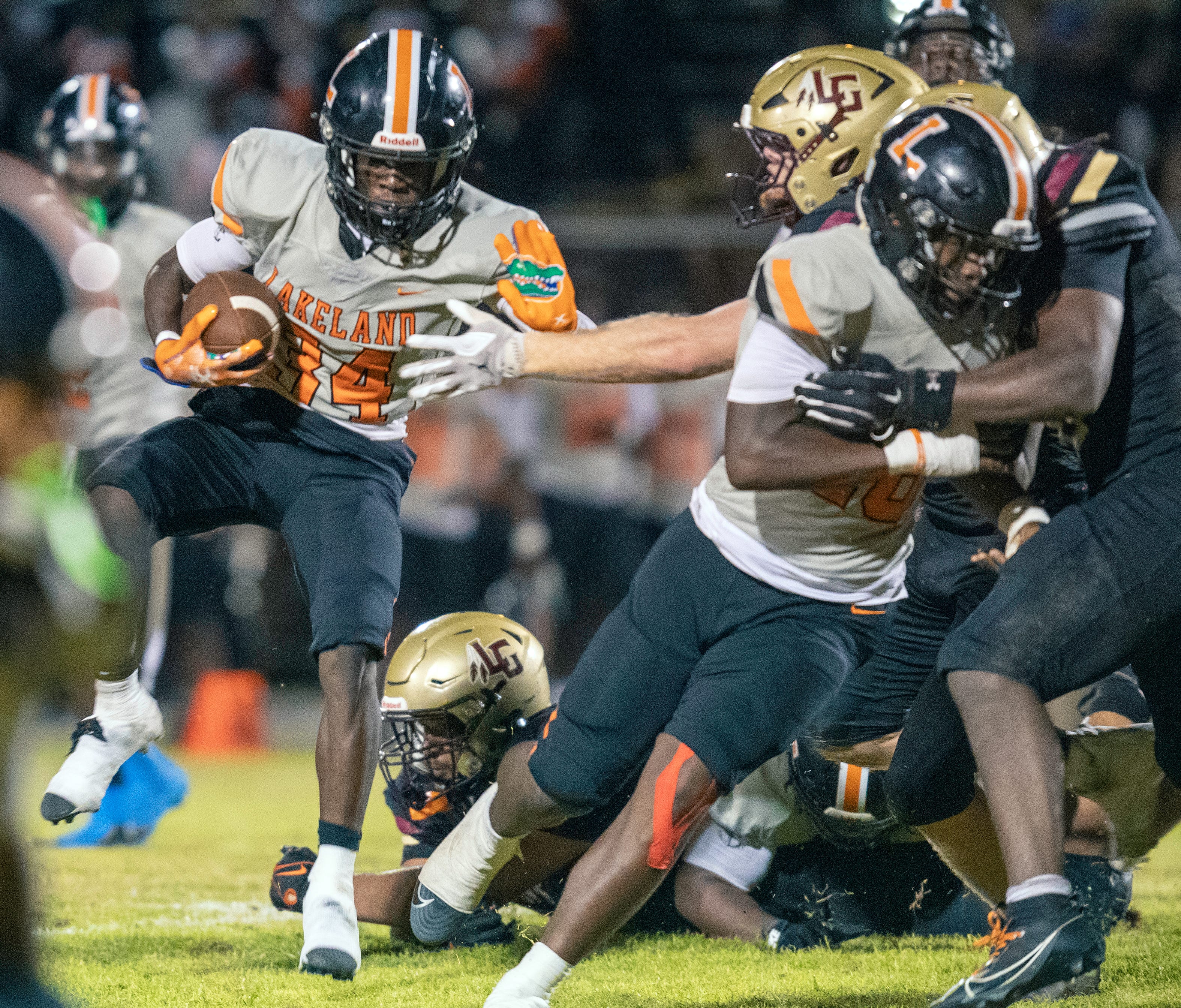 Lakeland running back Kevin Hendrix follow. block as he looks for running room against Lake Gibson Friday night at Virgil Ramage Stadium.