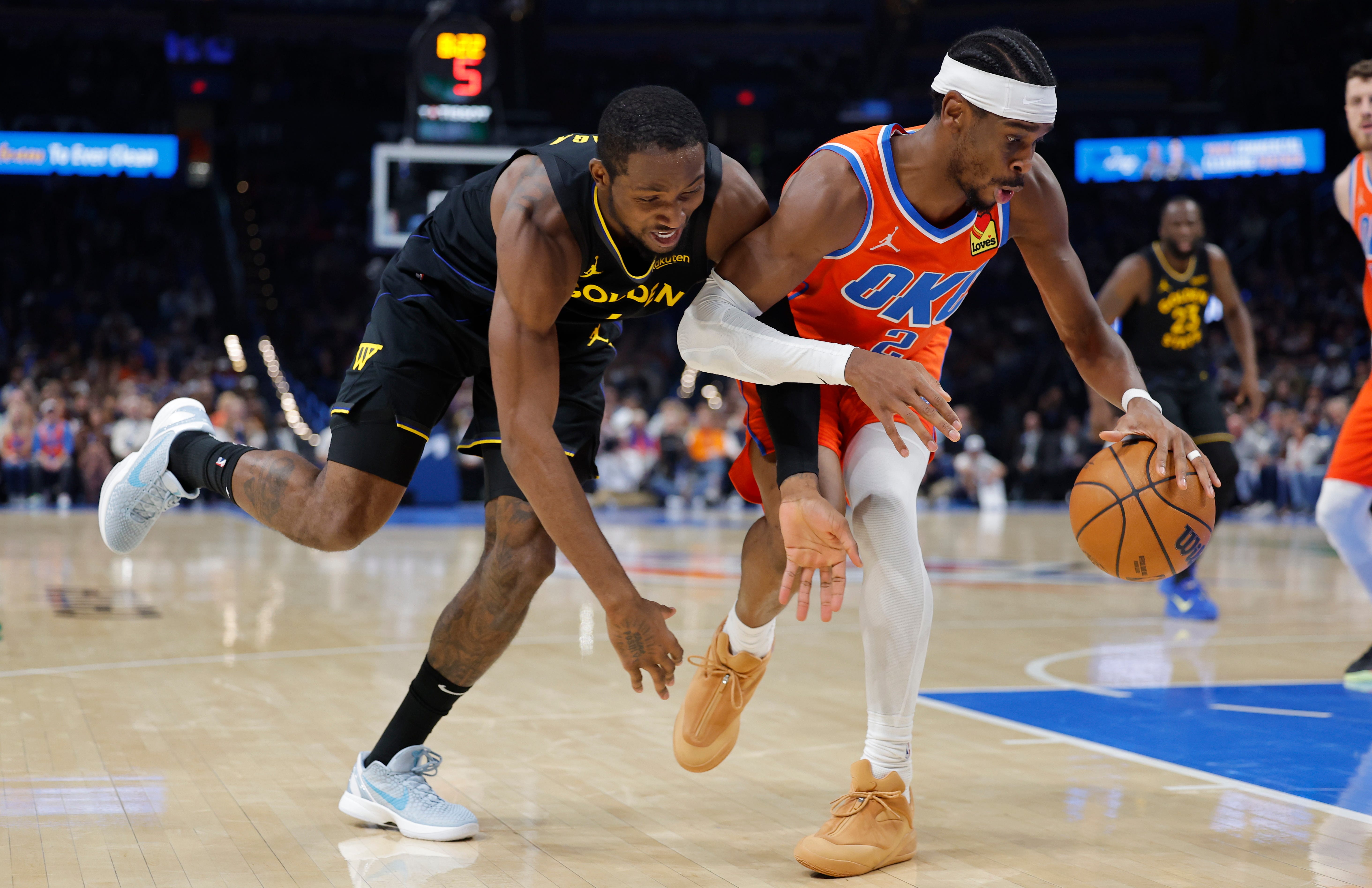 Nov 11, 2025; Oklahoma City, Oklahoma, USA; Golden State Warriors forward Jonathan Kuminga (1) and Oklahoma City Thunder guard Shai Gilgeous-Alexander (2) fight for control of the ball during the second half at Paycom Center. Mandatory Credit: Alonzo Adams-Imagn Images