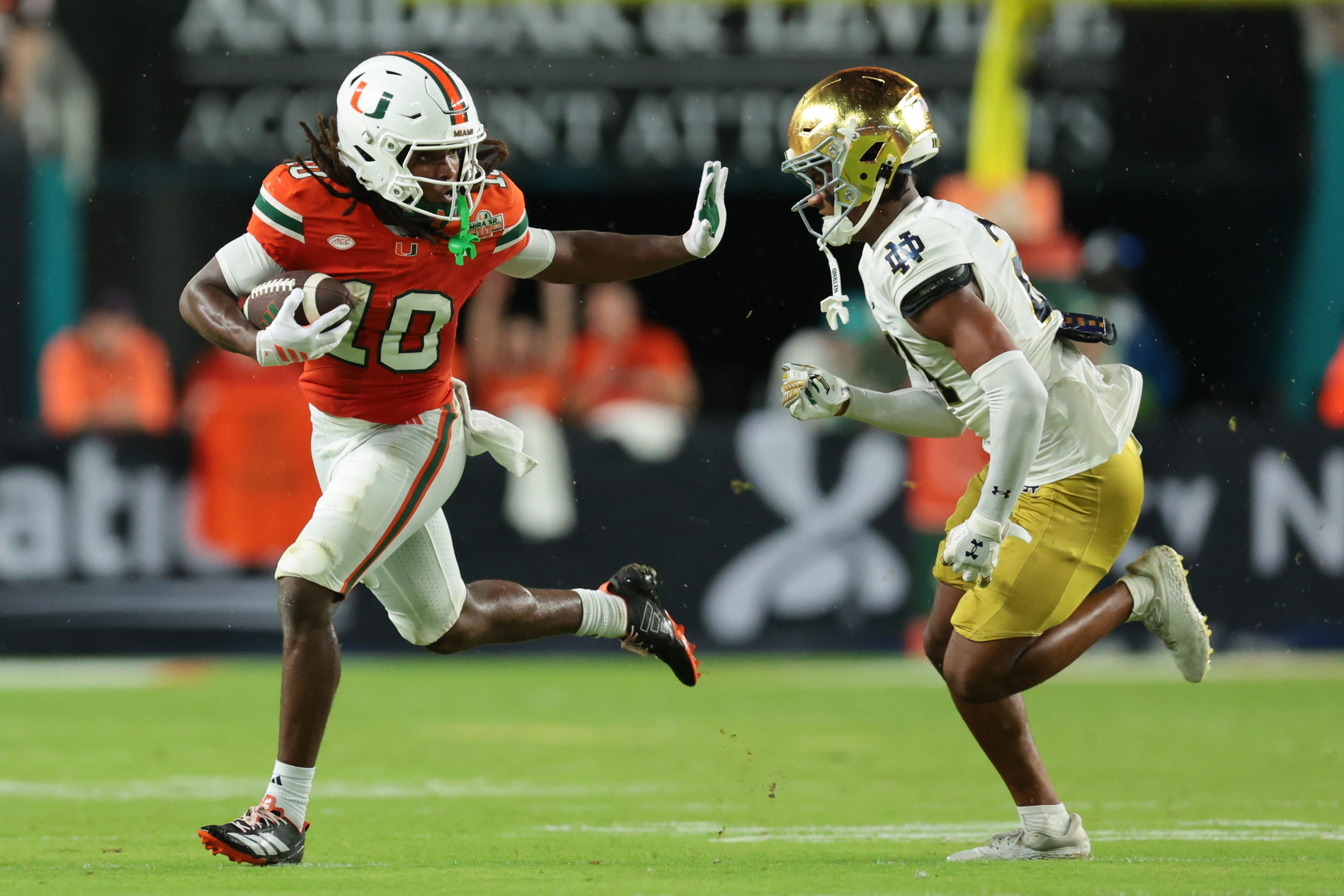 Aug 31, 2025; Miami Gardens, Florida, USA; Miami Hurricanes wide receiver Malachi Toney (10) runs with the football against Notre Dame Fighting Irish cornerback Karson Hobbs (21) during the first half at Hard Rock Stadium. Mandatory Credit: Sam Navarro-Imagn Images