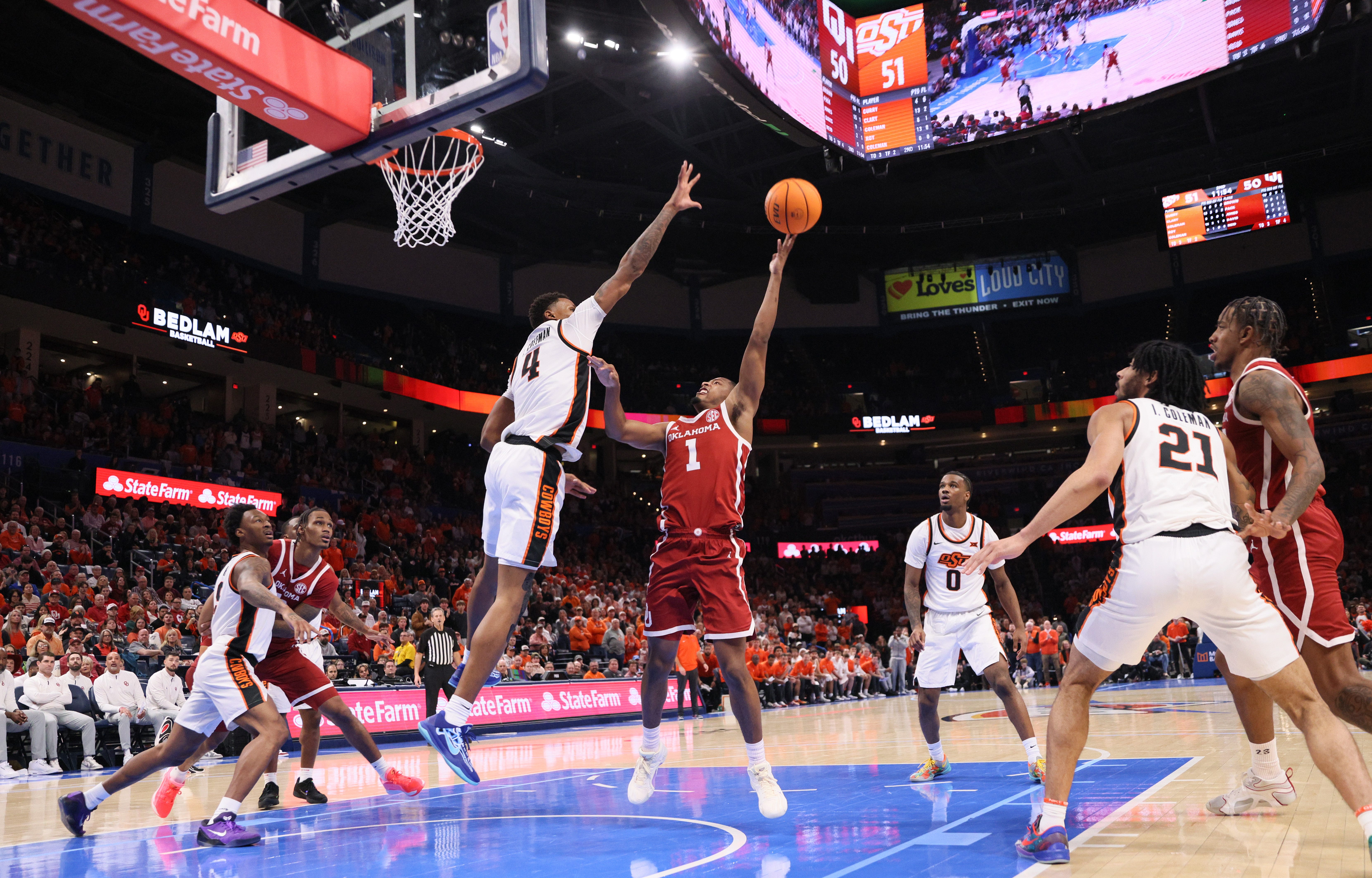 Oklahoma guard Xzayvier Brown (1) shoots over Oklahoma State forward Christian Coleman (4) during the second half of a Bedlam men's college basketball game between the OSU Cowboys and OU Sooners at Paycom Center in Oklahoma City, Saturday, Dec. 13, 2025.
