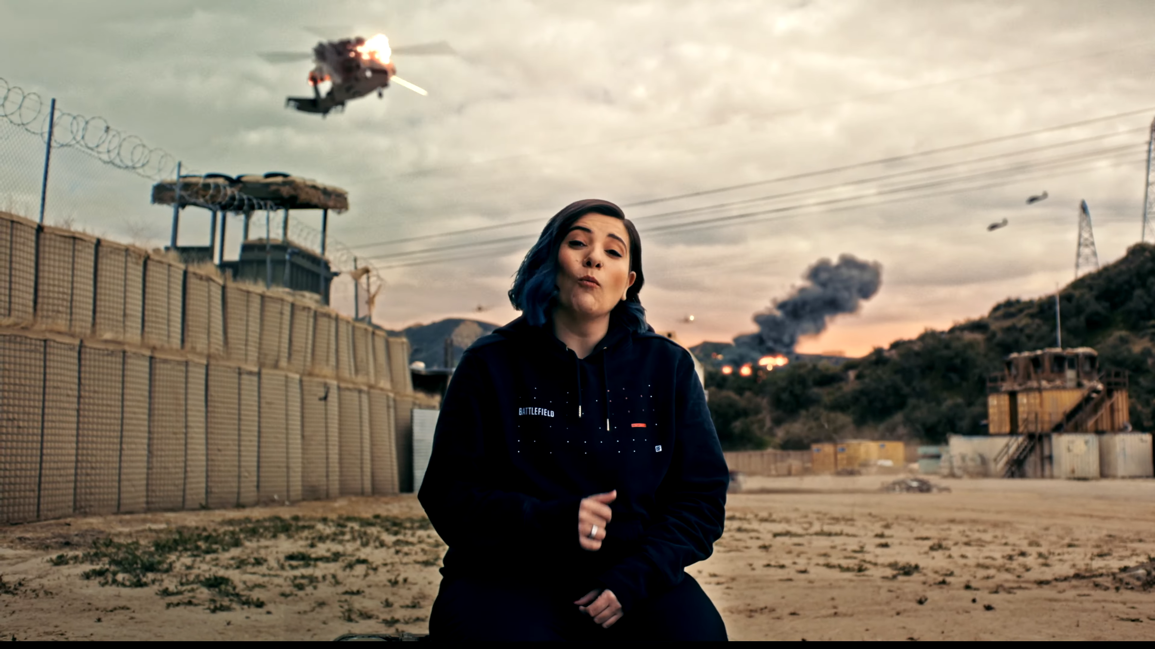 DICE producer Alexia Christofi with a helicopter taking AA fire behind in Battlefield 6 mutliplayer reveal.