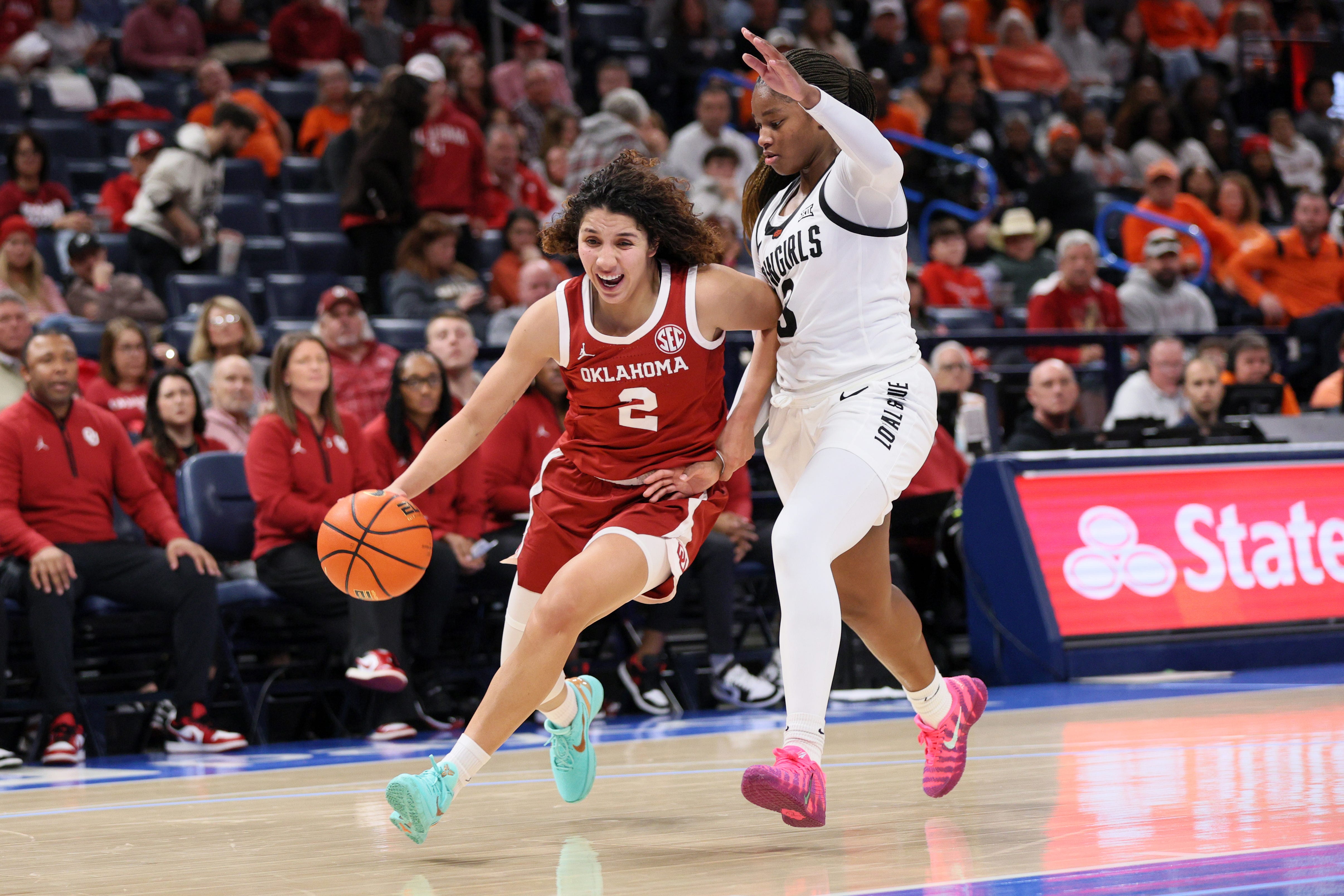 Oklahoma guard Aaliyah Chavez (2) drives against Oklahoma State guard Micah Gray (3) during the second half of a Bedlam women's college basketball game between the OSU Cowgirls and OU Sooners at Paycom Center in Oklahoma City, Saturday, Dec. 13, 2025.