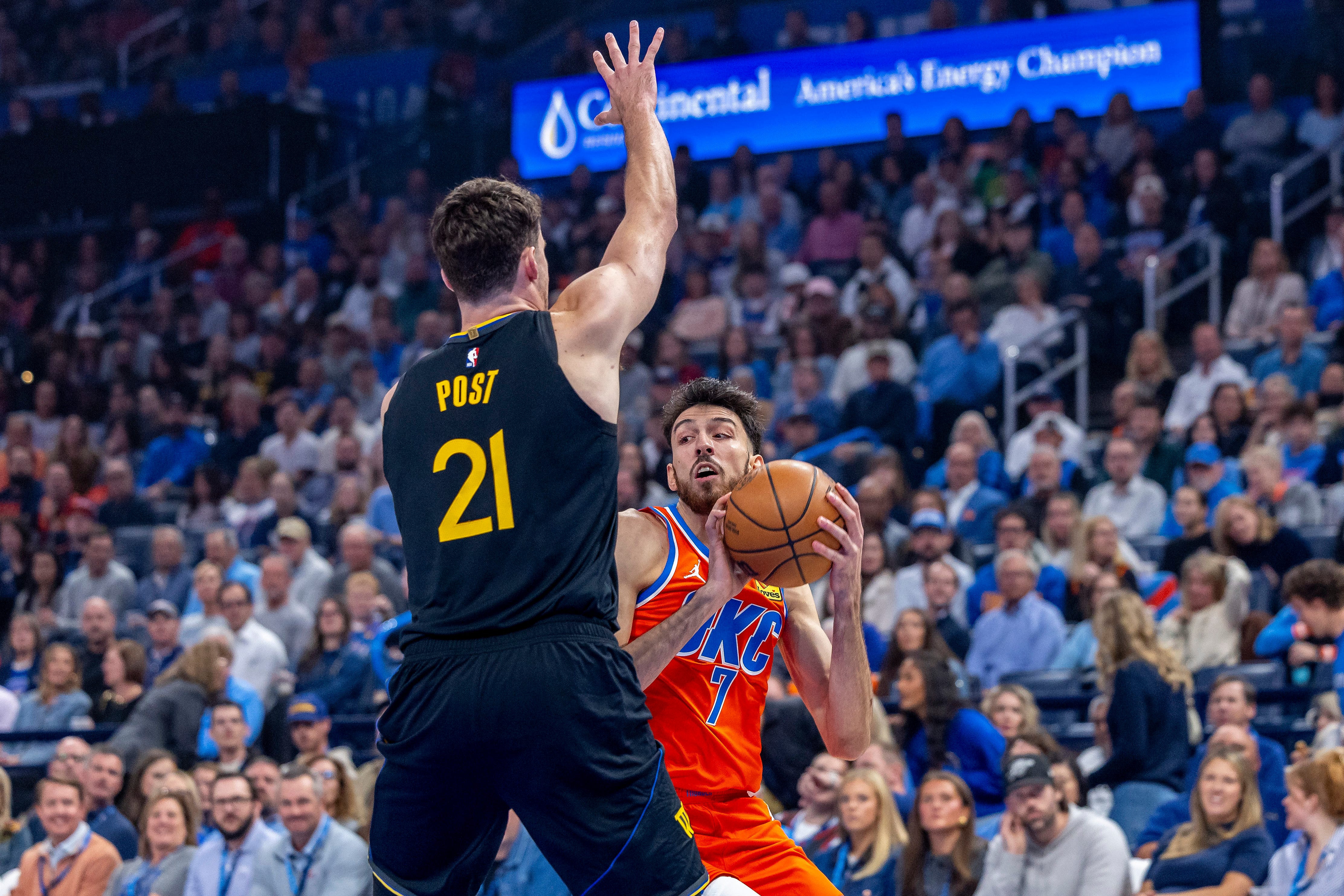 Nov 11, 2025; Oklahoma City, Oklahoma, USA; Golden State Warriors center Quinten Post (21) defends a drive by Oklahoma City Thunder center Chet Holmgren (7) during the first quarter at Paycom Center. Mandatory Credit: Alonzo Adams-Imagn Images