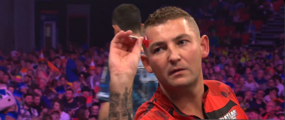 Nathan Aspinall throws dart at World Grand Prix against Luke Humphries