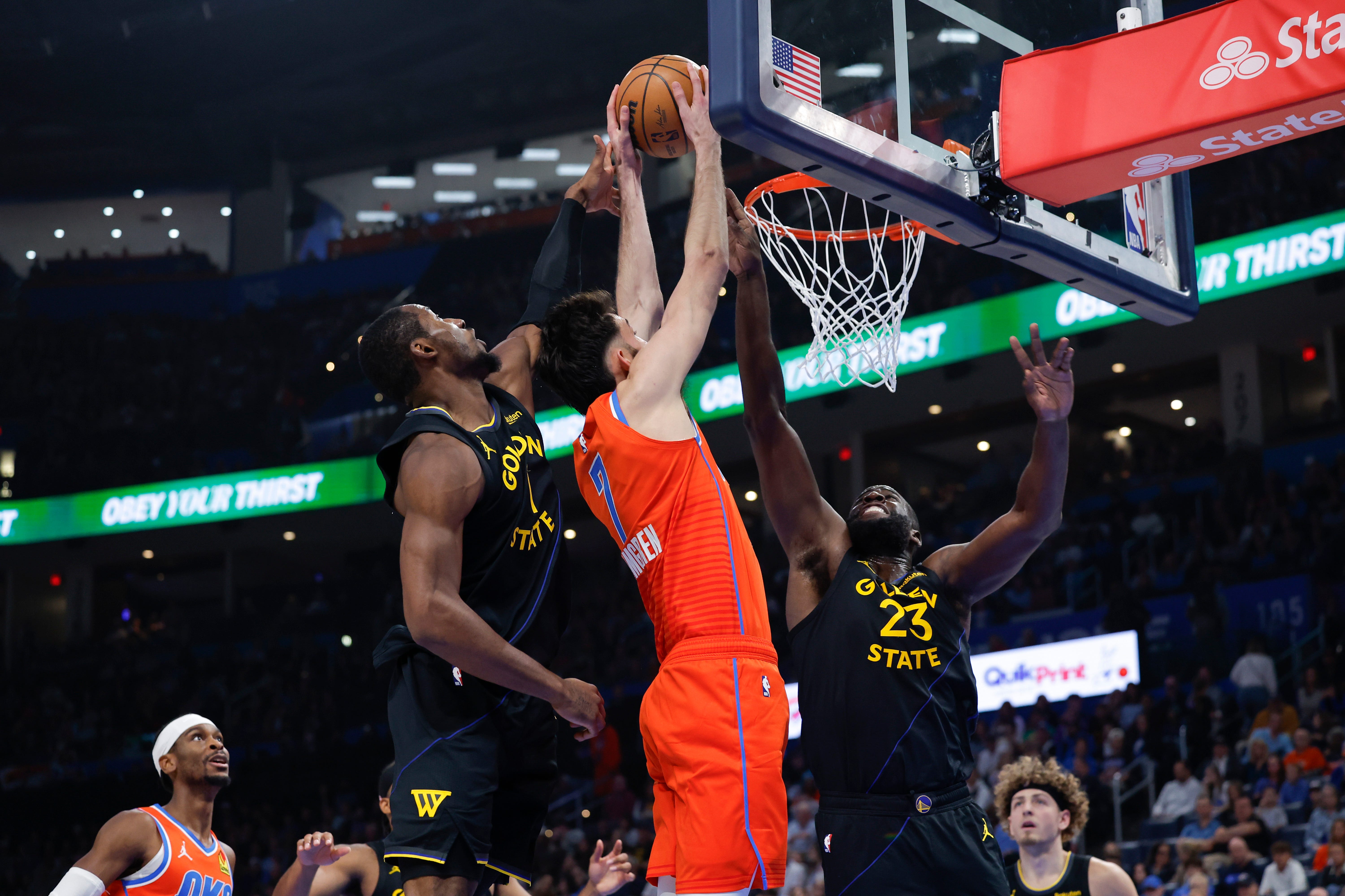 Nov 11, 2025; Oklahoma City, Oklahoma, USA; Oklahoma City Thunder center Chet Holmgren (7) goes to the basket as Golden State Warriors forward Draymond Green (23) defends during the second quarter at Paycom Center. Mandatory Credit: Alonzo Adams-Imagn Images