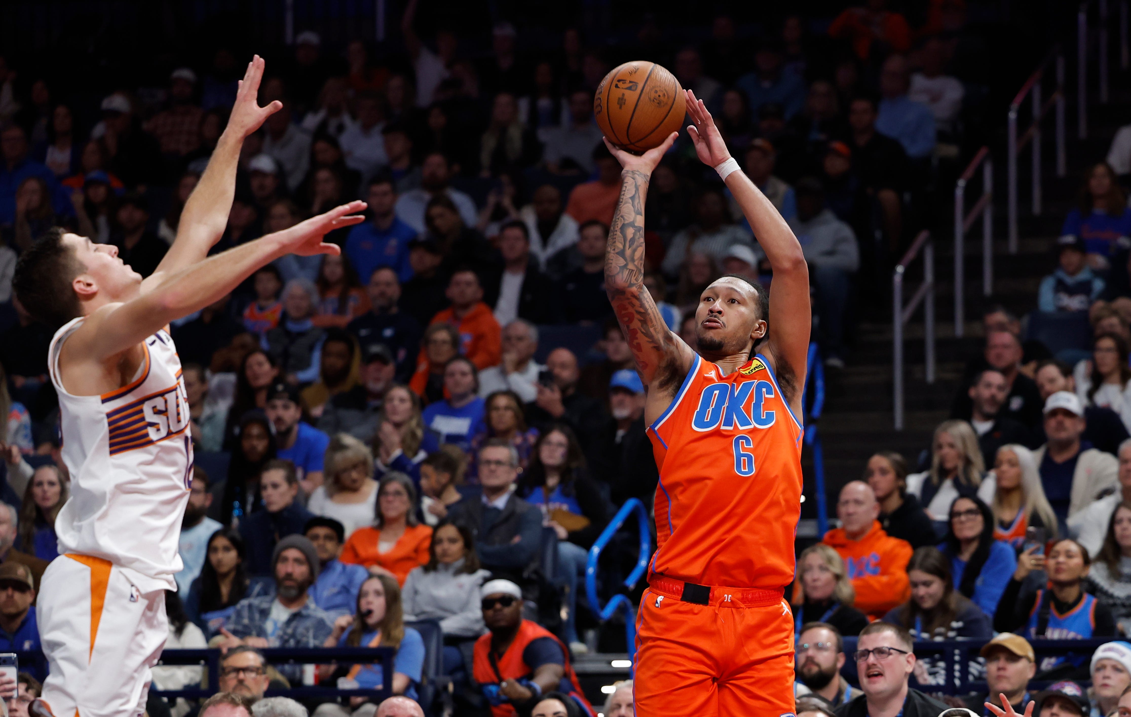 Nov 28, 2025; Oklahoma City, Oklahoma, USA; Oklahoma City Thunder forward Jaylin Williams (6) shoots a three point basket over Phoenix Suns guard Collin Gillespie (12) during the second half at Paycom Center. Mandatory Credit: Alonzo Adams-Imagn Images