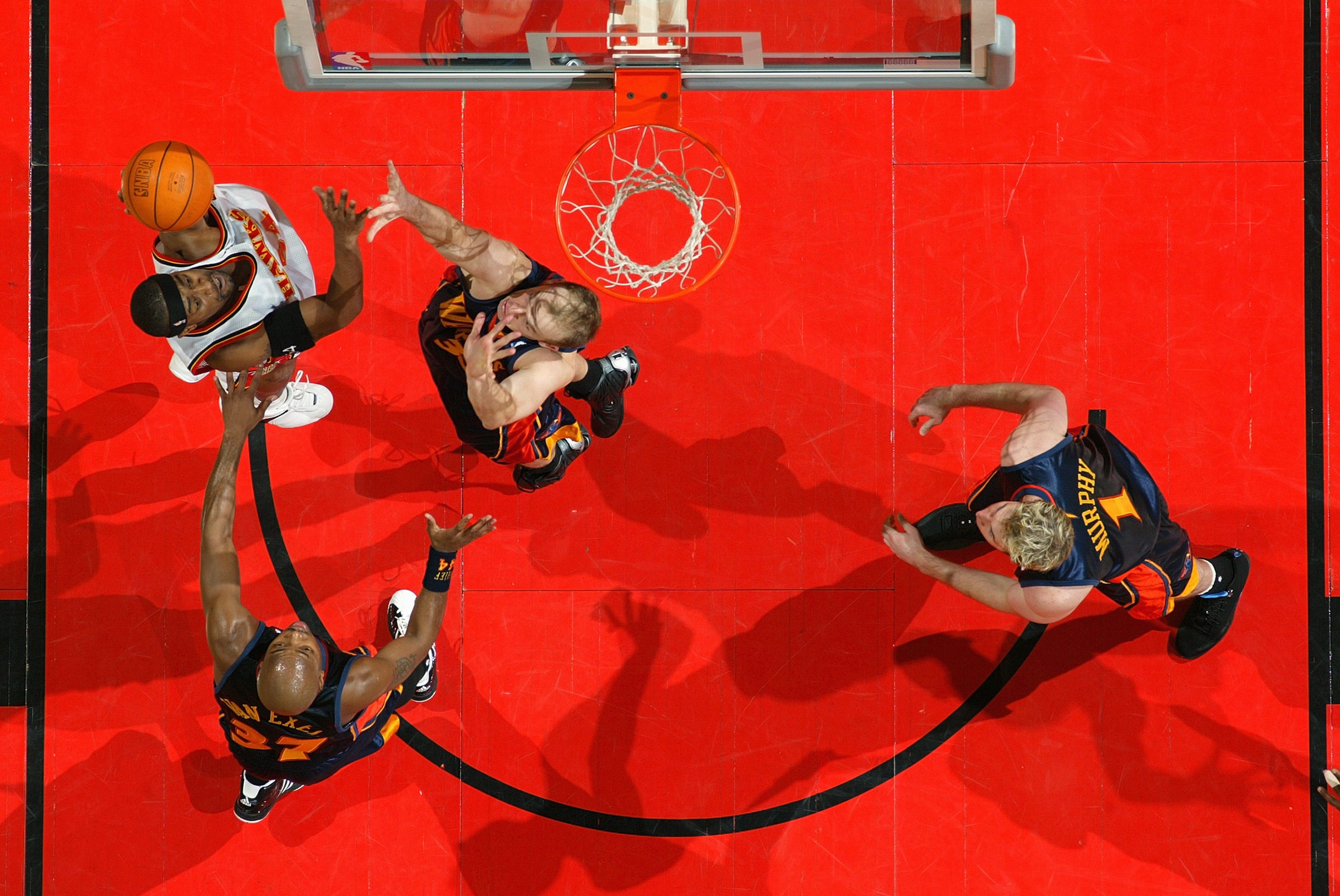 ATLANTA - DECEMBER 17: Lee Nailon #54 of the Atlanta Hawks shoots against Brian Cardinal #35, Nick Van Exel #37 and Troy Murphy #1 of the Golden State Warriors during the game on December 17, 2003 at Philips Arena in Atlanta, Georgia. The Warriors won 98-85. NOTE TO USER: User expressly acknowledges and agrees that, by downloading and/or using this Photograph, User is consenting to the terms and conditions of the Getty Images License Agreement. (Photo by Jamie Squire/Getty Images)