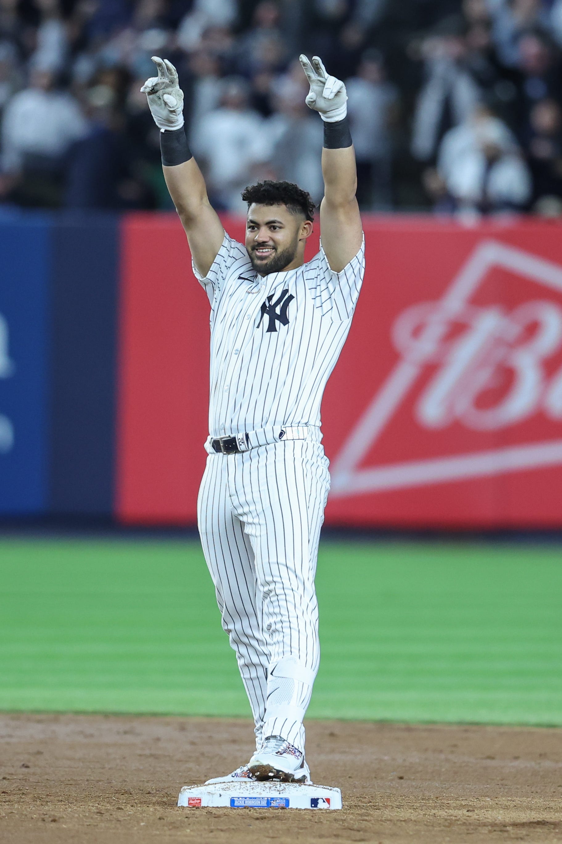 New York Yankees left fielder Jasson Dominguez (24) gestures after hitting a three run double in the sixth inning against the Kansas City Royals at Yankee Stadium. All players wore #42 for Jackie Robinson Day.