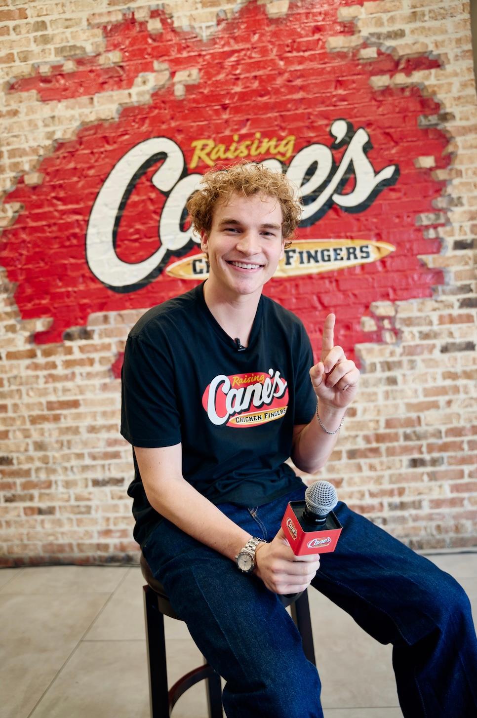Aiden Ross at Raising Cane's holding up one finger