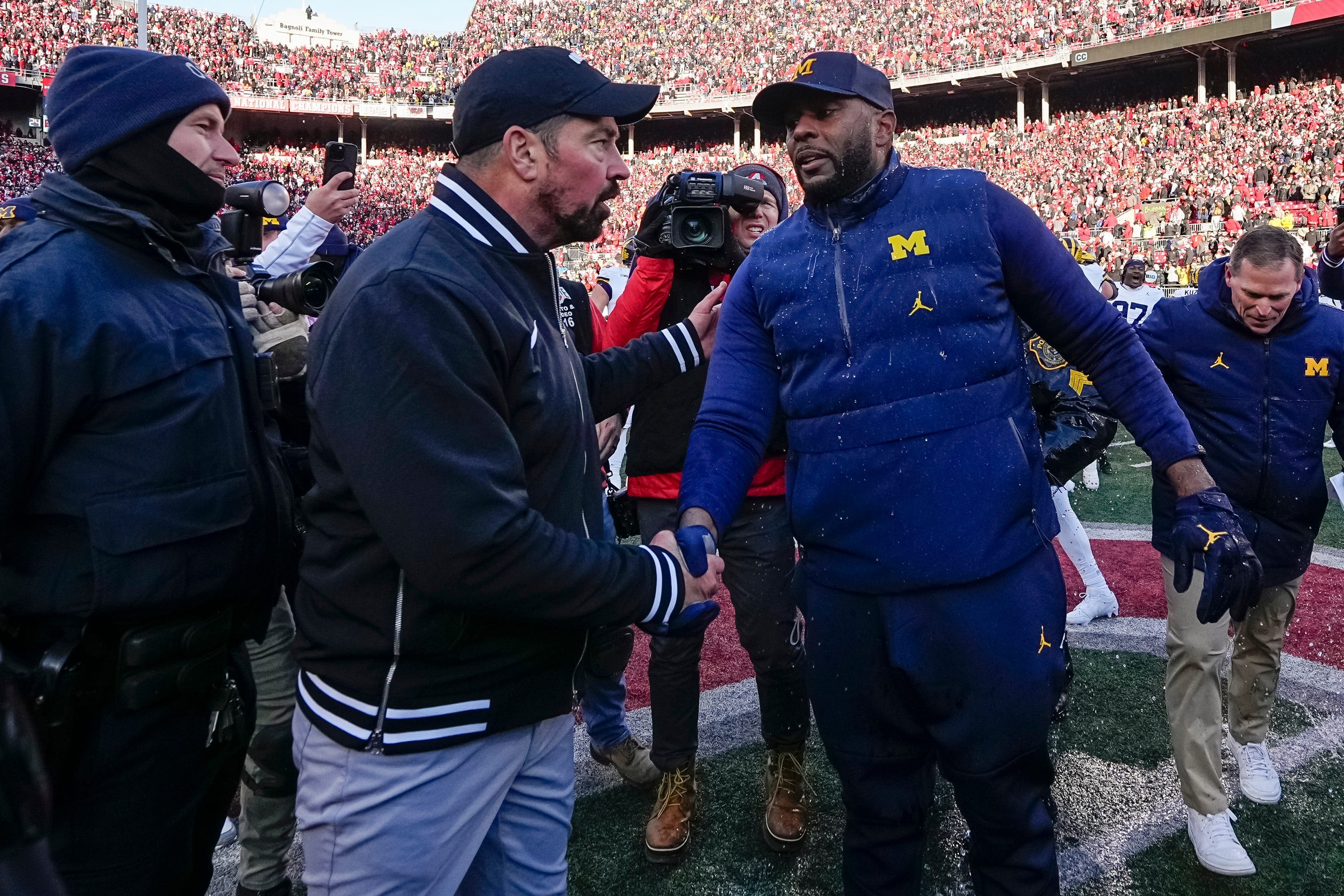Ohio State Buckeyes head coach Ryan Day shakes hands with Michigan Wolverines head coach Sherrone Moore following Michigan's 13-10 victory in 2024 at Ohio Stadium.