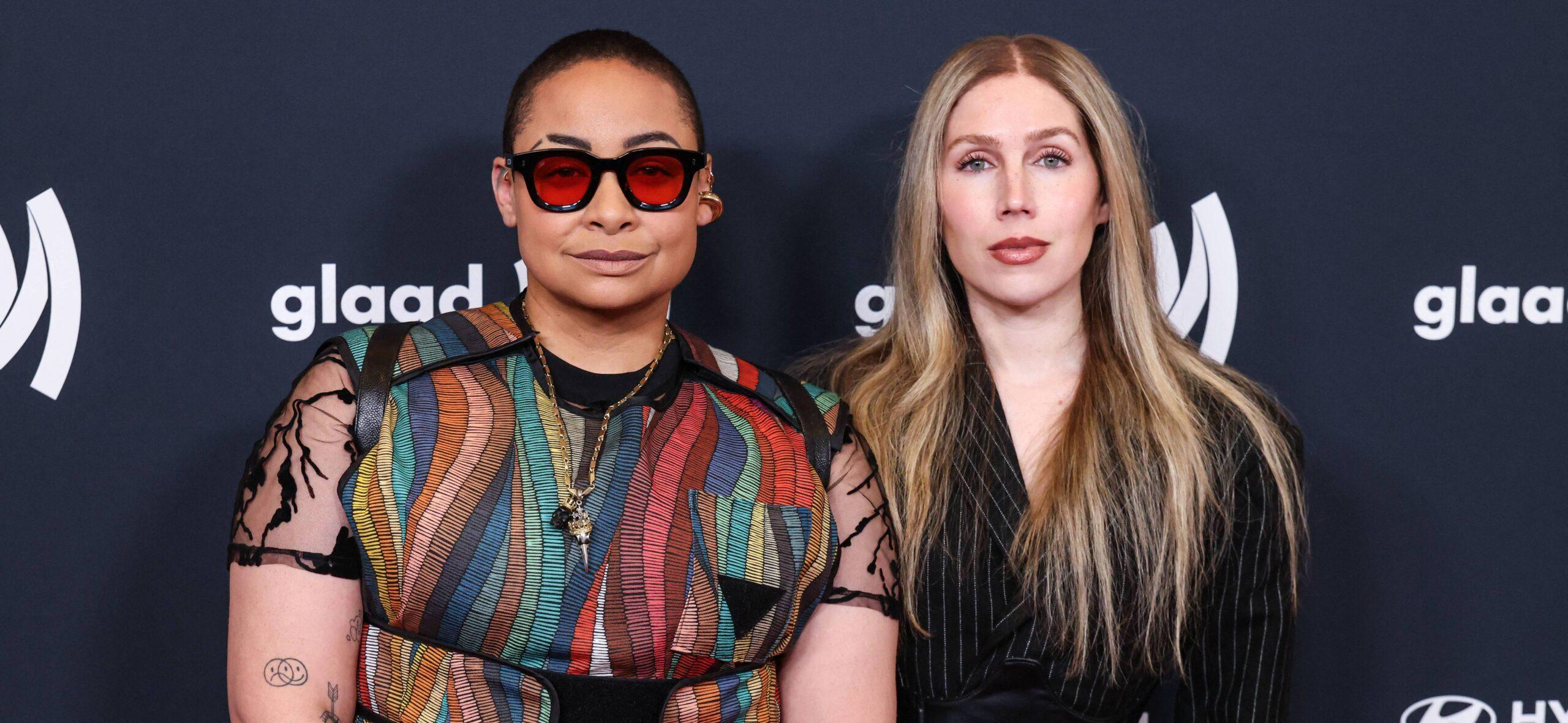 Raven Symon&eacute; and her wife posing on red carpet.