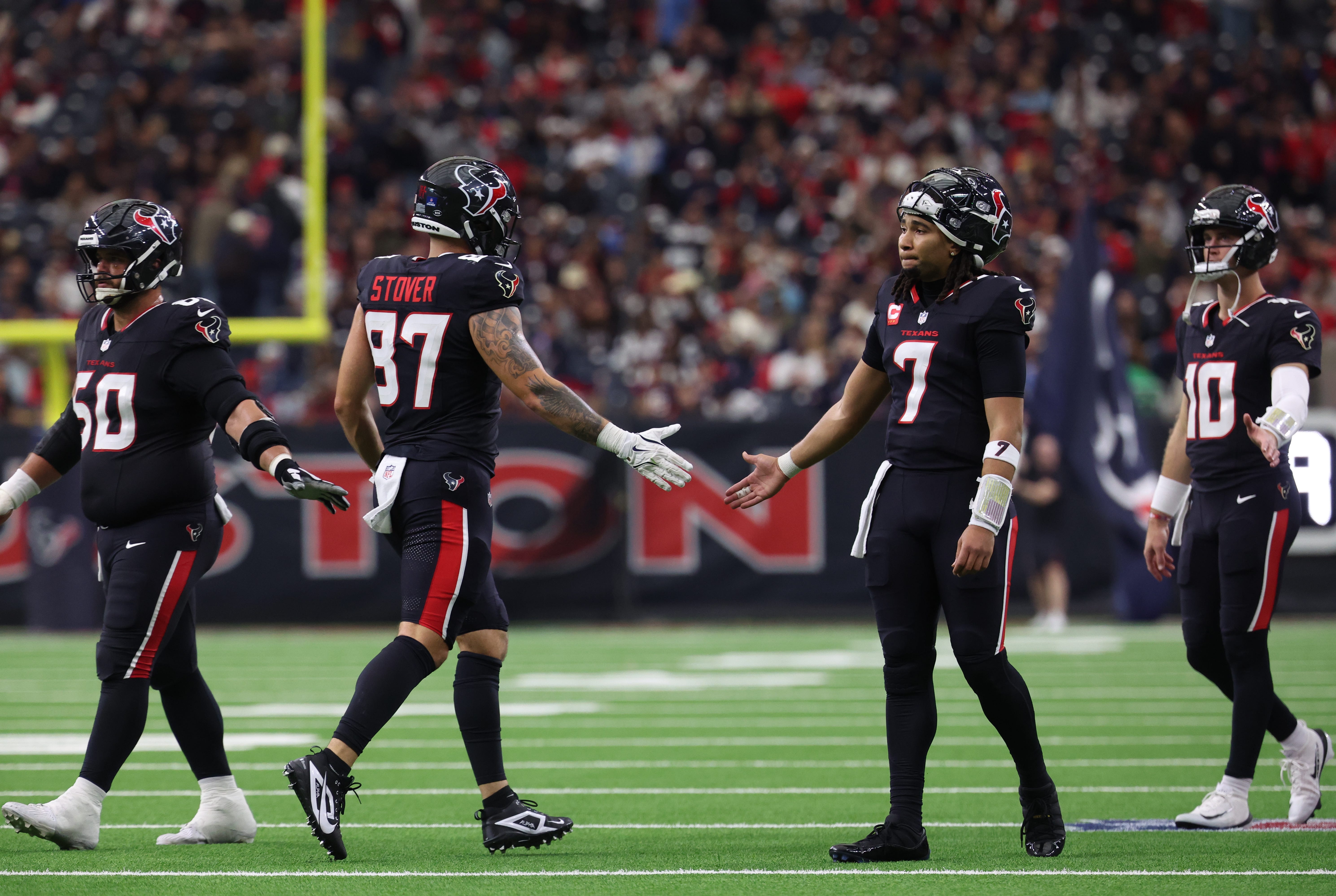 Dec 14, 2025; Houston, Texas, USA; Houston Texans quarterback C.J. Stroud (7) high-fives tight end Cade Stover (87) during the second quarter against the Arizona Cardinals at NRG Stadium. Mandatory Credit: Thomas Shea-Imagn Images