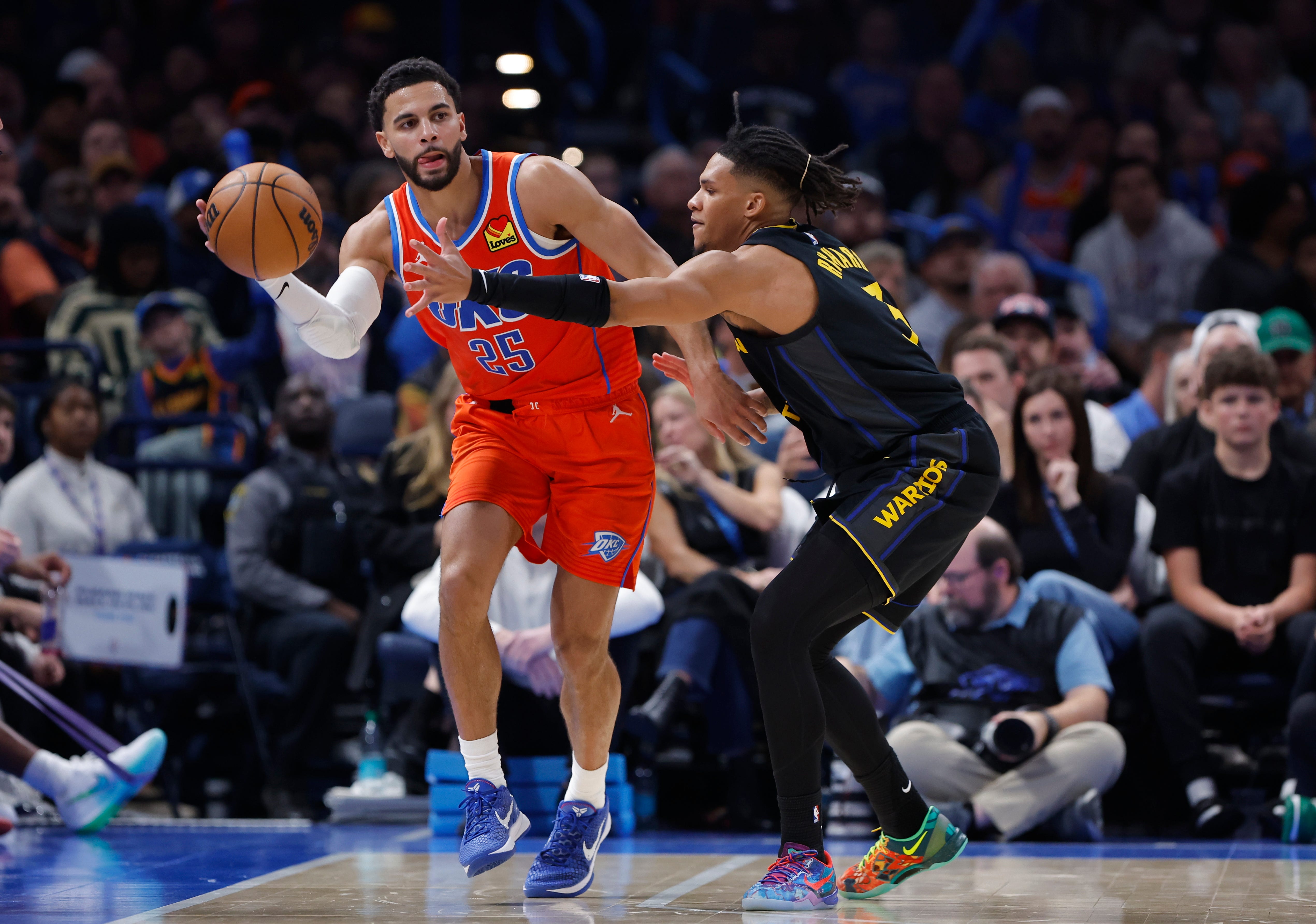 Nov 11, 2025; Oklahoma City, Oklahoma, USA;Oklahoma City Thunder guard Ajay Mitchell (25) passes around Golden State Warriors guard Will Richard (3) during the second half at Paycom Center. Mandatory Credit: Alonzo Adams-Imagn Images