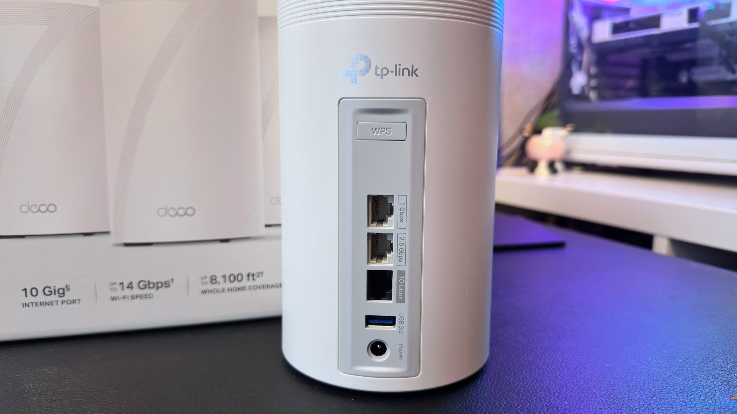 A photo of a TP-Link Deco BE68 mesh router, showing its WAN/LAN ports.