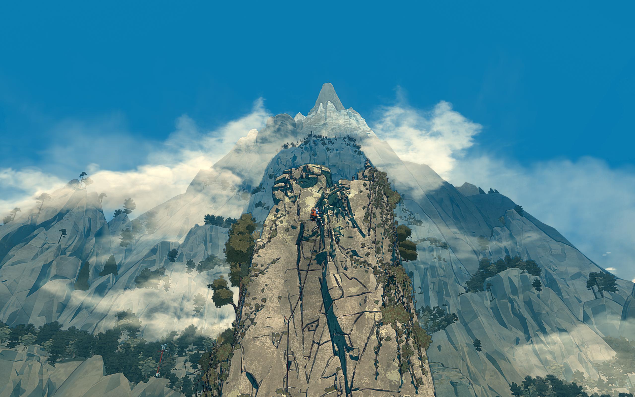 A woman climbs a cliff face with another, larger mountain in the background