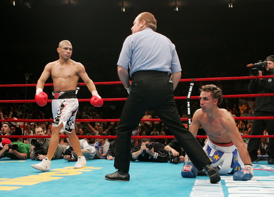 NEW YORK - JUNE 10: (L-R) Miguel Cotto of Puerto Rico walks to the opposite corner of the ring after knocking down Paul Malignaggi during their WBO Junior Welterweight Title on June 10, 2006 at Madison Square Garden in New York City. (Photo by Nick Laham/Getty Images)