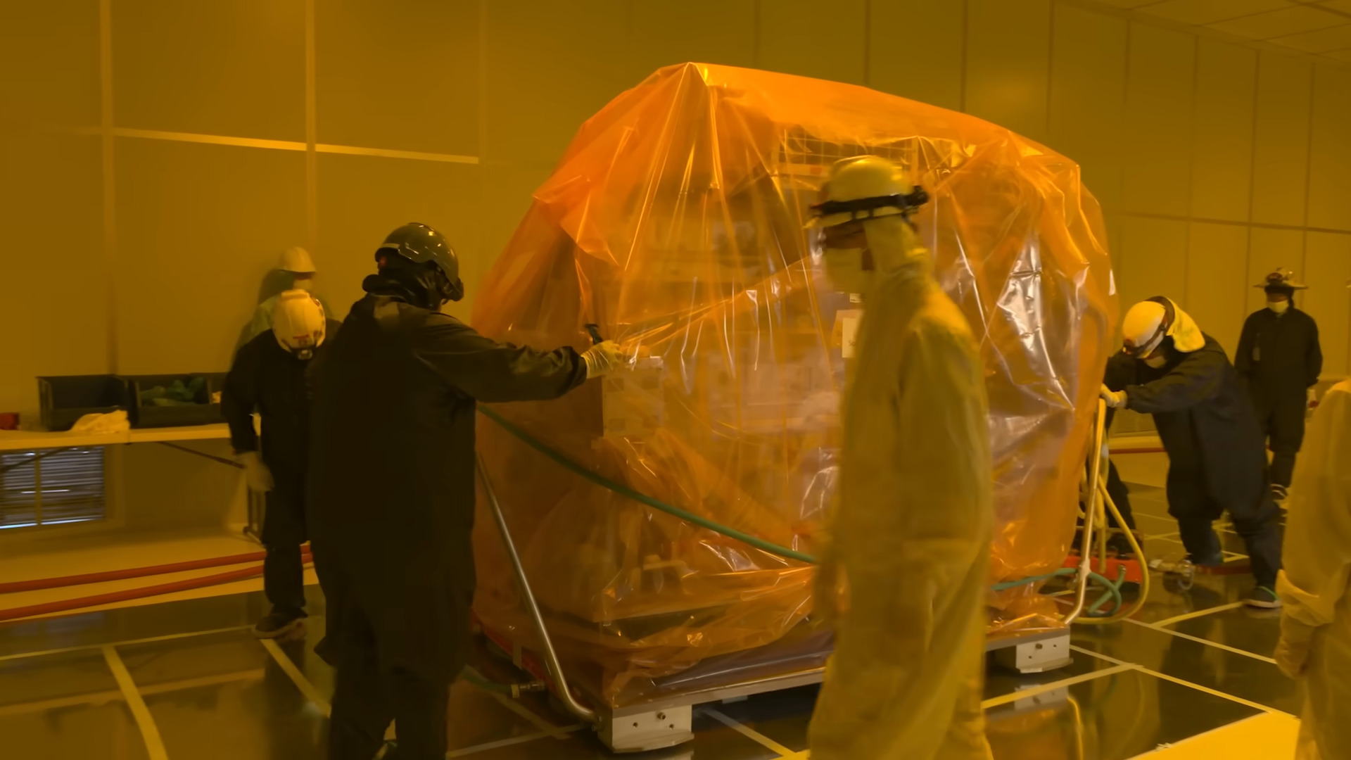 An advanced lithography machine being escorted into the TSMC Arizona chipmaking facility