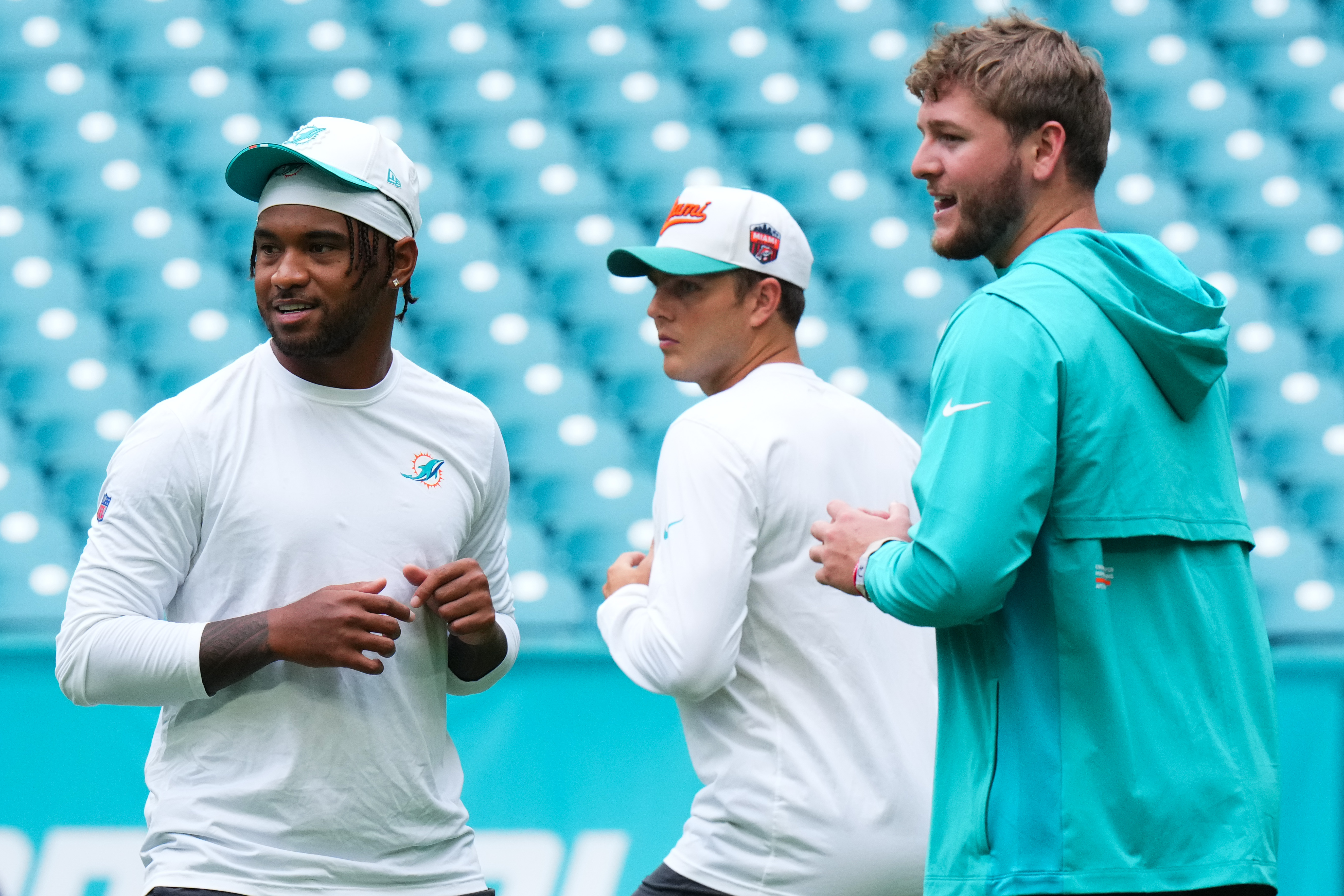 MIAMI GARDENS, FLORIDA - AUGUST 23: Tua Tagovailoa #1, Zach Wilson #0 and Quinn Ewers #14 of the Miami Dolphins warm up prior to a NFL Preseason 2025 game between Jacksonville Jaguars and Miami Dolphins at Hard Rock Stadium on August 23, 2025 in Miami Gardens, Florida. (Photo by Rich Storry/Getty Images)