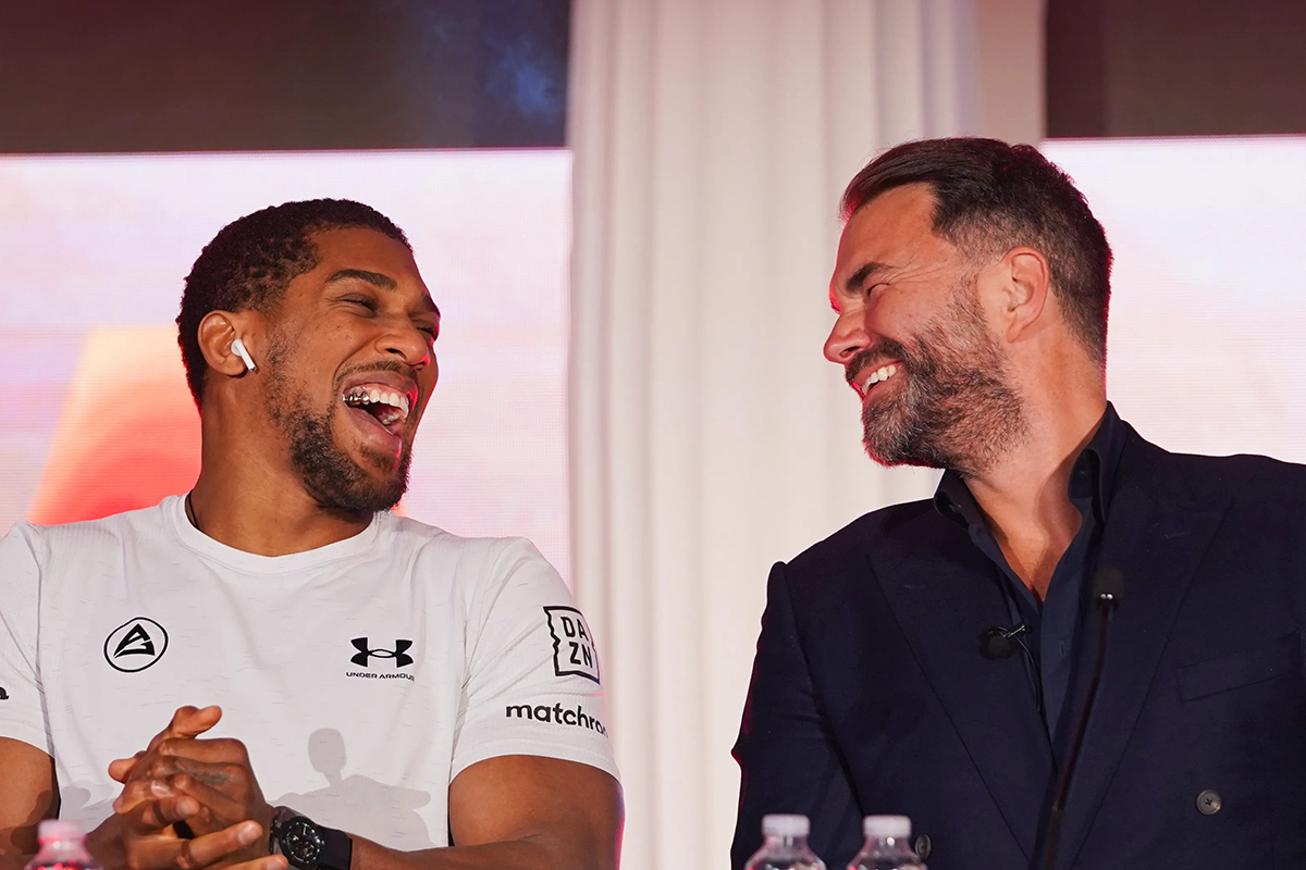 Anthony Joshua and Eddie Hearn laughing together.