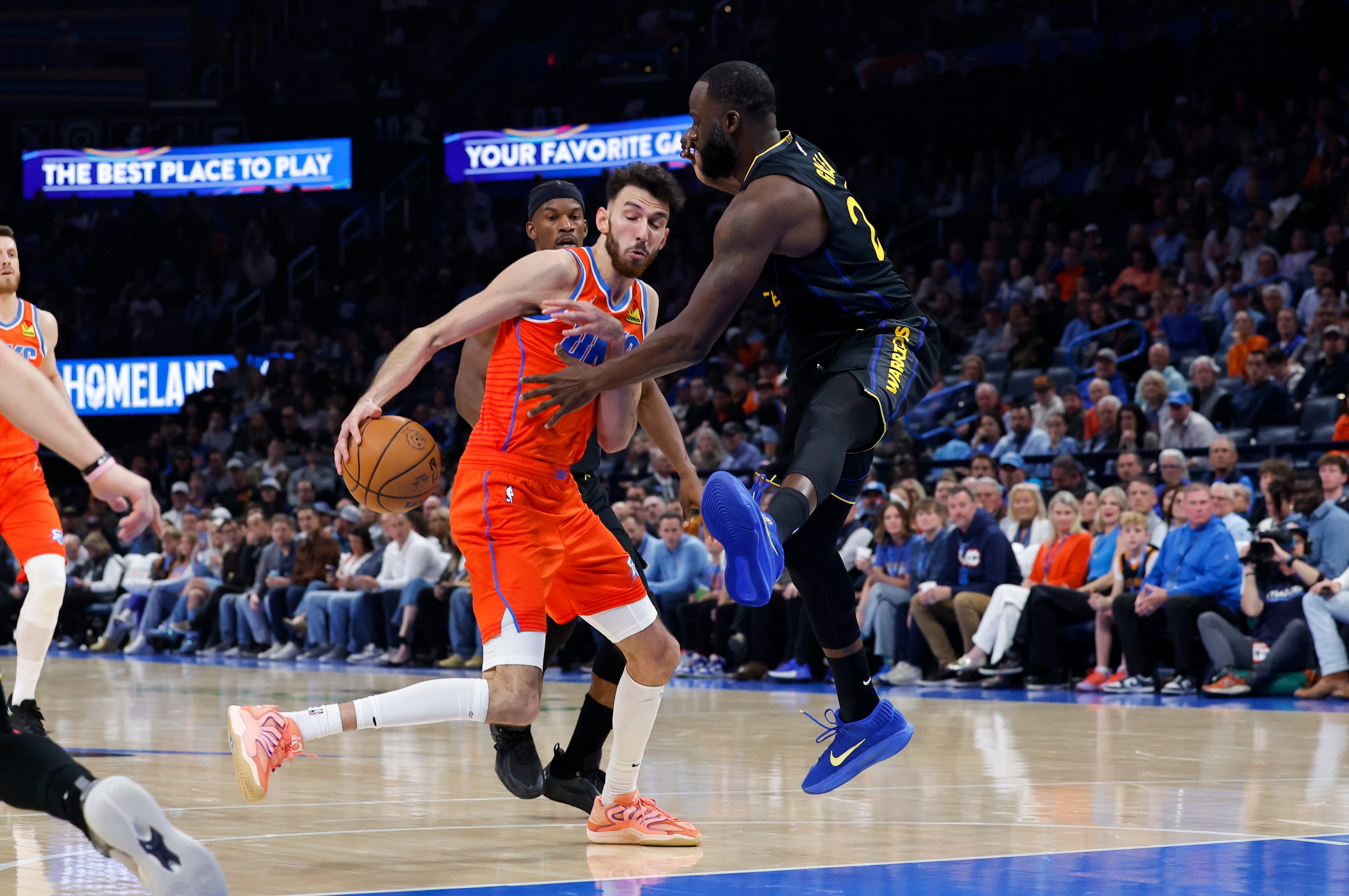 Nov 11, 2025; Oklahoma City, Oklahoma, USA; Golden State Warriors forward Draymond Green (23) defends a drive by Oklahoma City Thunder center Chet Holmgren (7) during the second quarter at Paycom Center. Mandatory Credit: Alonzo Adams-Imagn Images