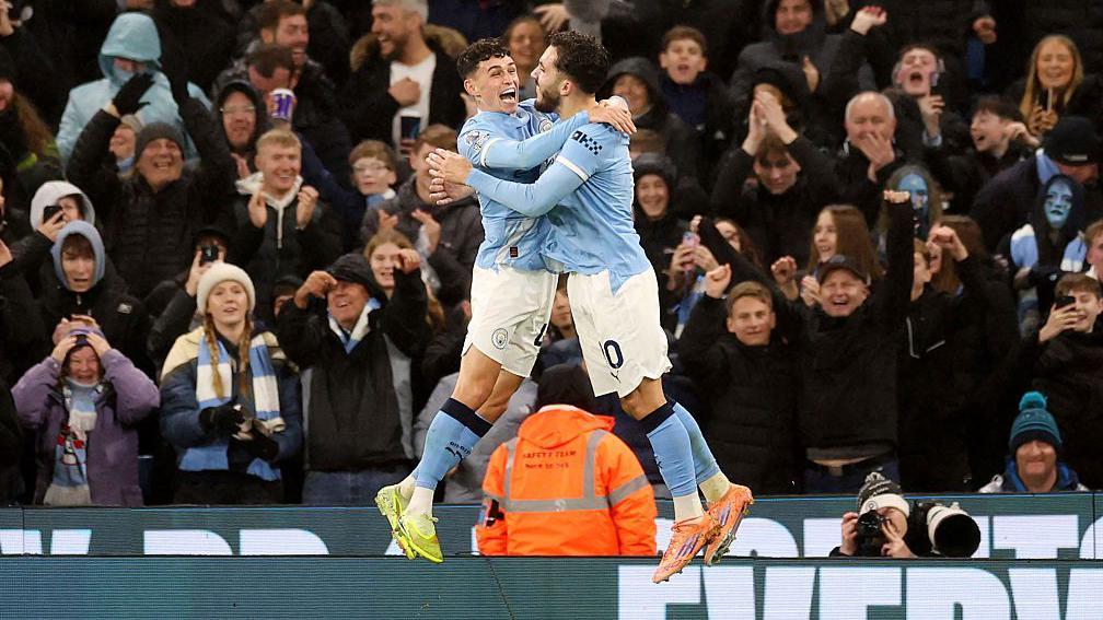Phil Foden and Rayan Cherki hug