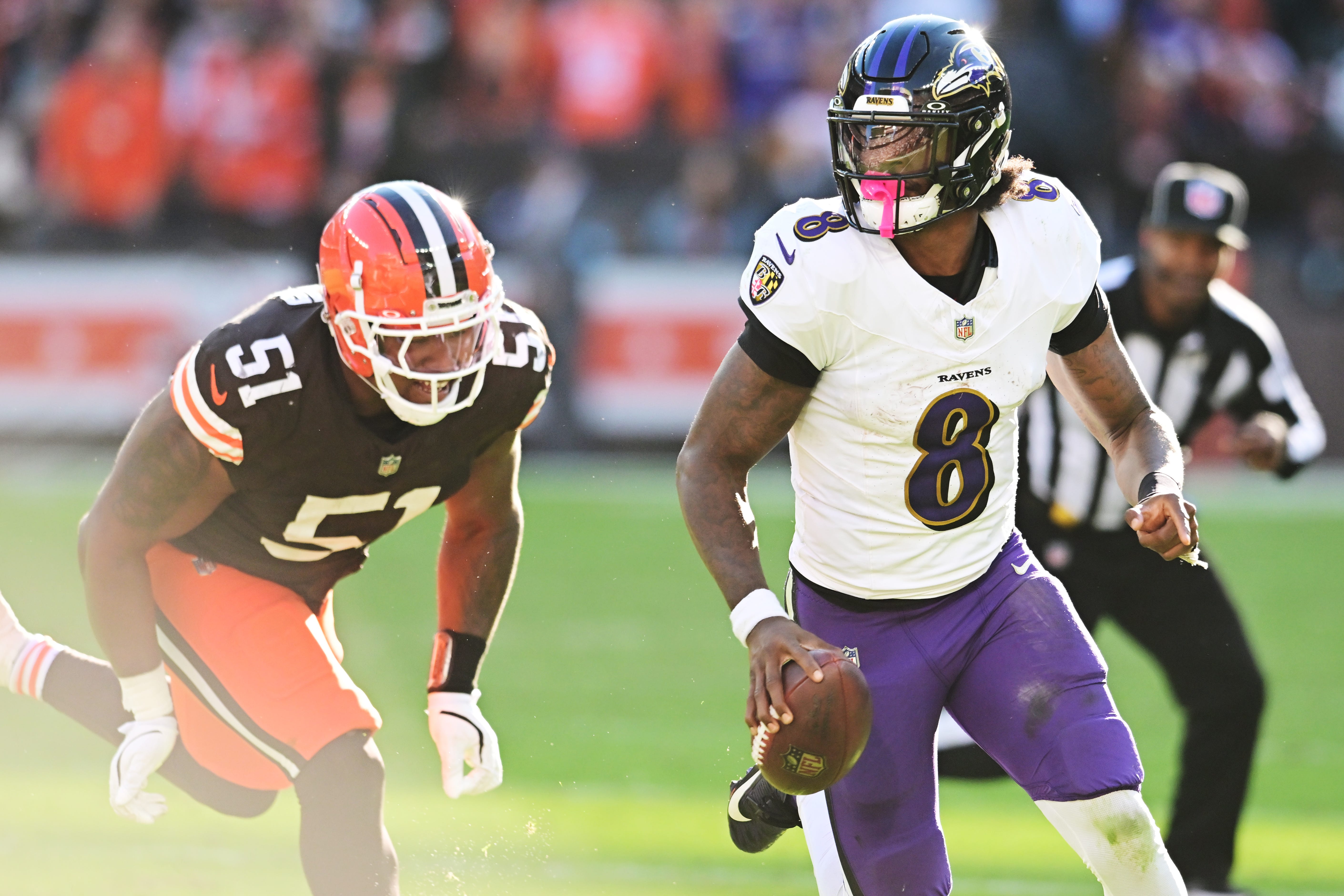 Oct 27, 2024; Cleveland, Ohio, USA; Baltimore Ravens quarterback Lamar Jackson (8) scrambles from Cleveland Browns defensive tackle Mike Hall Jr. (51) during the second half at Huntington Bank Field. Mandatory Credit: Ken Blaze-Imagn Images