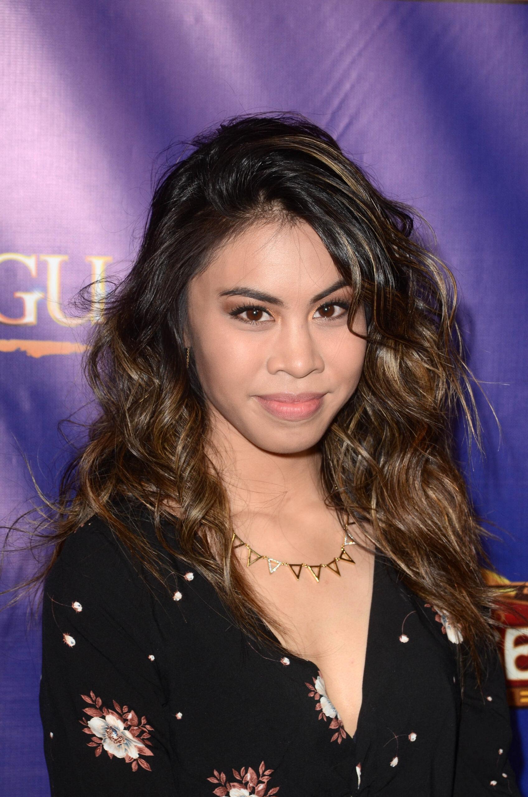 Ashley Argota posing on the red carpet. 