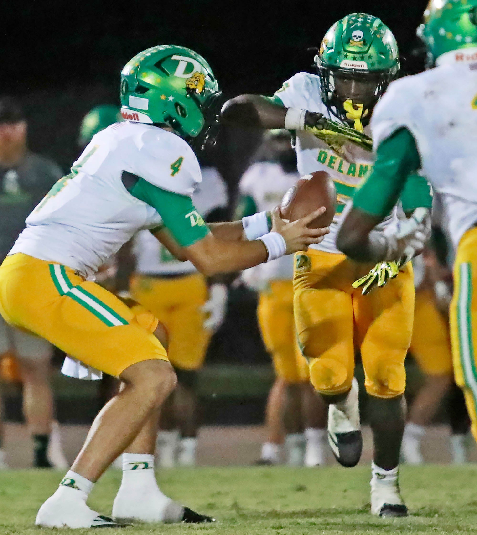 DeLand&rsquo;s Gardner Nordman (4) hands the ball to Taihj Moore (5) during the game against Spruce Creek, Tuesday, Nov. 4, 2025 hosted by Spruce Creek.