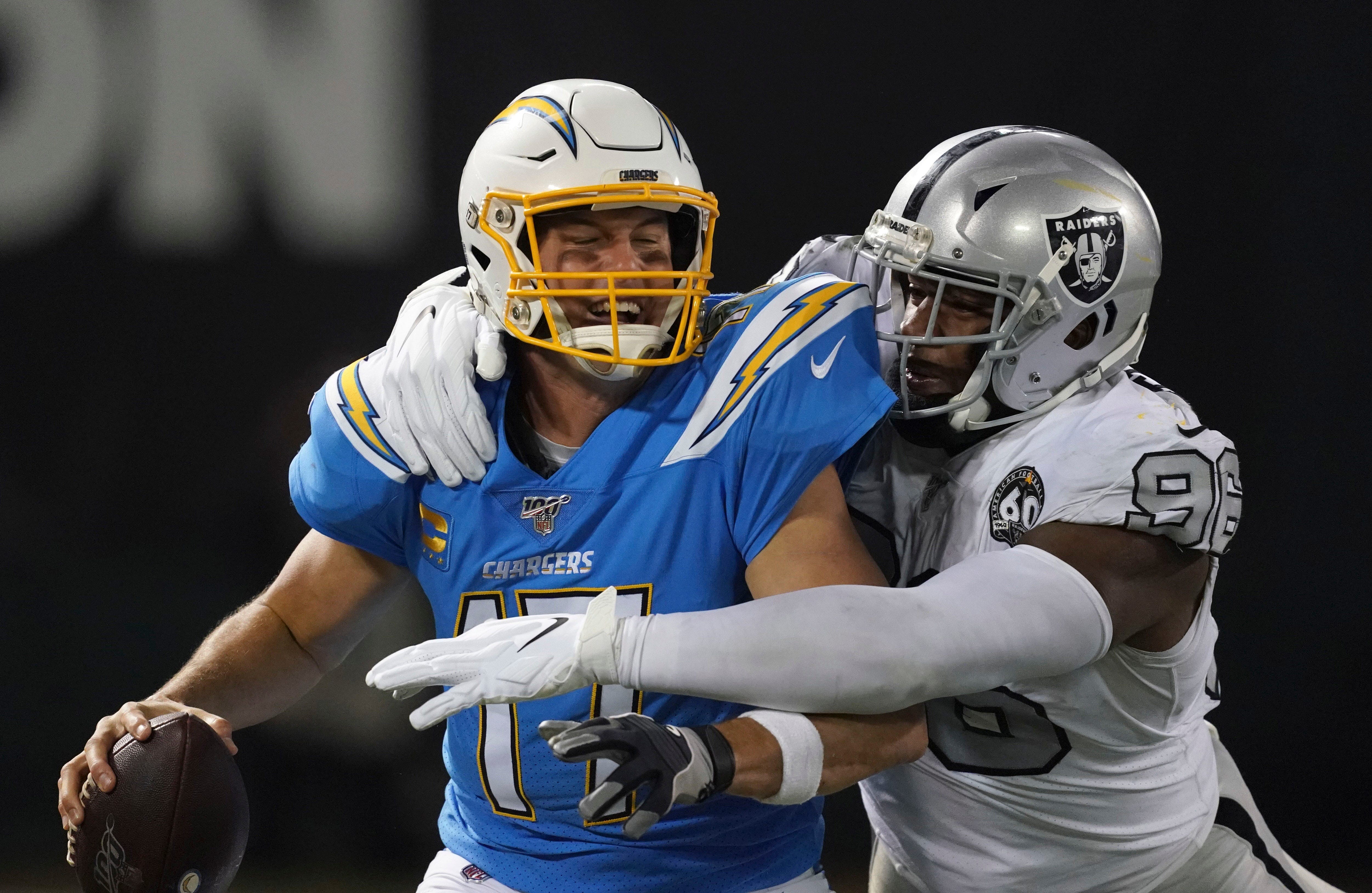 Chargers quarterback Philip Rivers is sacked by Oakland Raiders defensive end Clelin Ferrell.