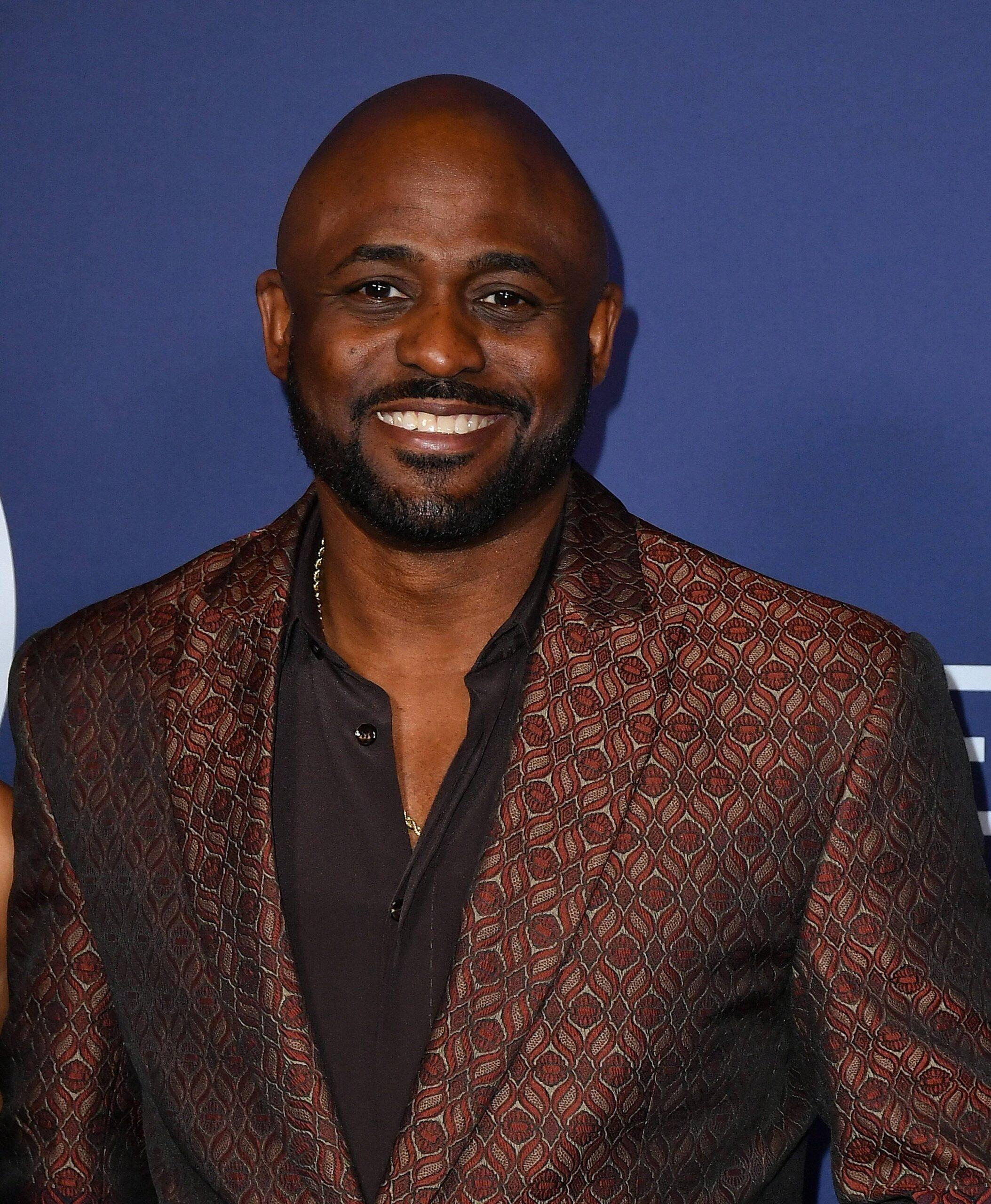 Wayne Brady posing on the red carpet. 