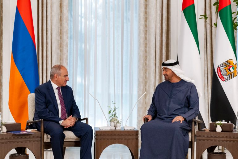 This handout picture provided by the UAE Presidential Court shows UAE President Sheikh Mohamed bin Zayed al-Nahyan receiving Armenia's Prime Minister Nikol Pashinyan at Shati Palace in Abu Dhabi on July 9, 2025.