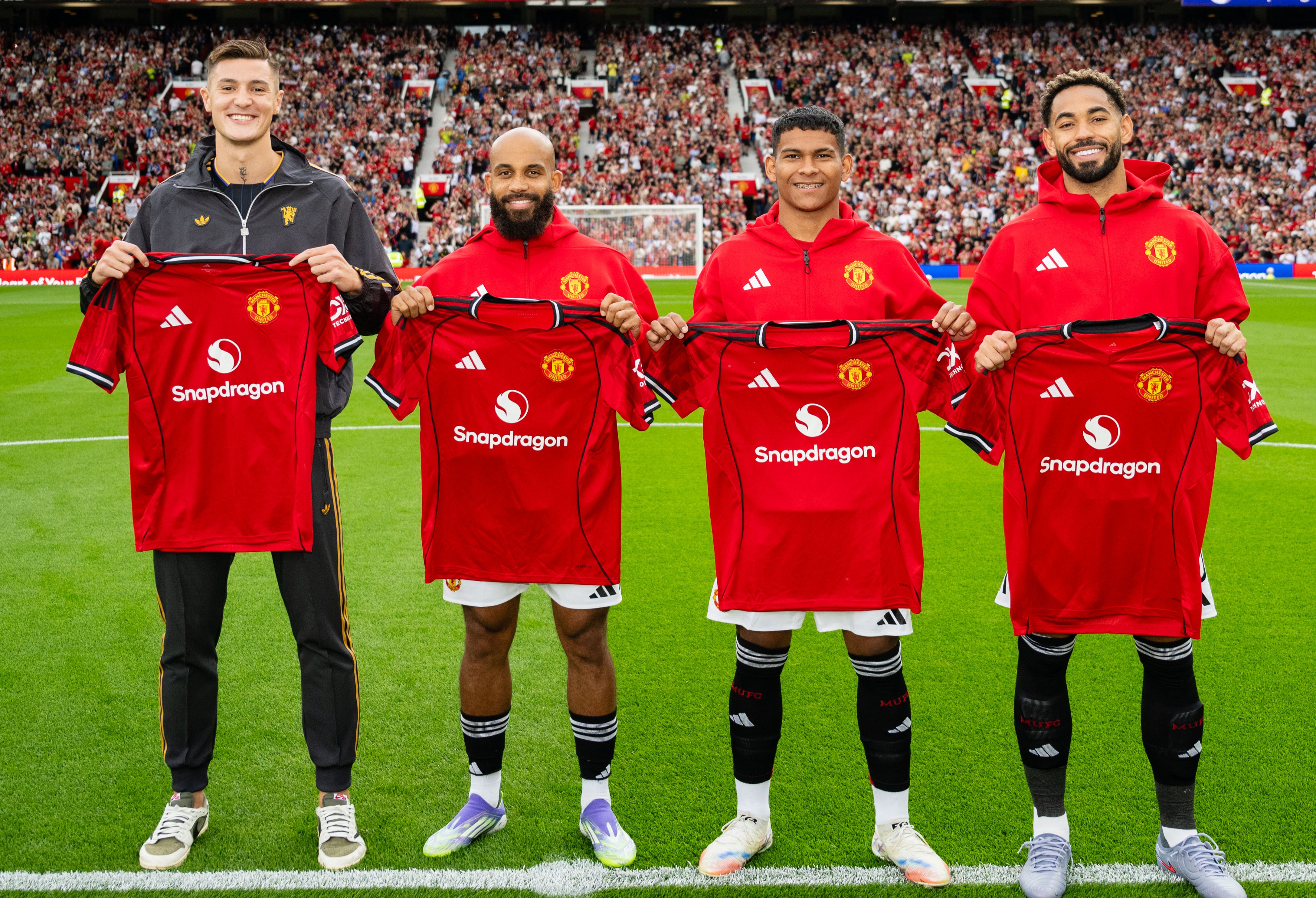 MANCHESTER, ENGLAND - AUGUST 9: (L-R) New Manchester United signings Benjamin Sesko, Bryan Mbeumo Diego Leon & Matheus Cunha pose together with team shirts prior to the pre-season friendly match between Manchester United and ACF Fiorentina at Old Trafford on August 9, 2025 in Manchester, England. (Photo by Ash Donelon/Manchester United via Getty Images)