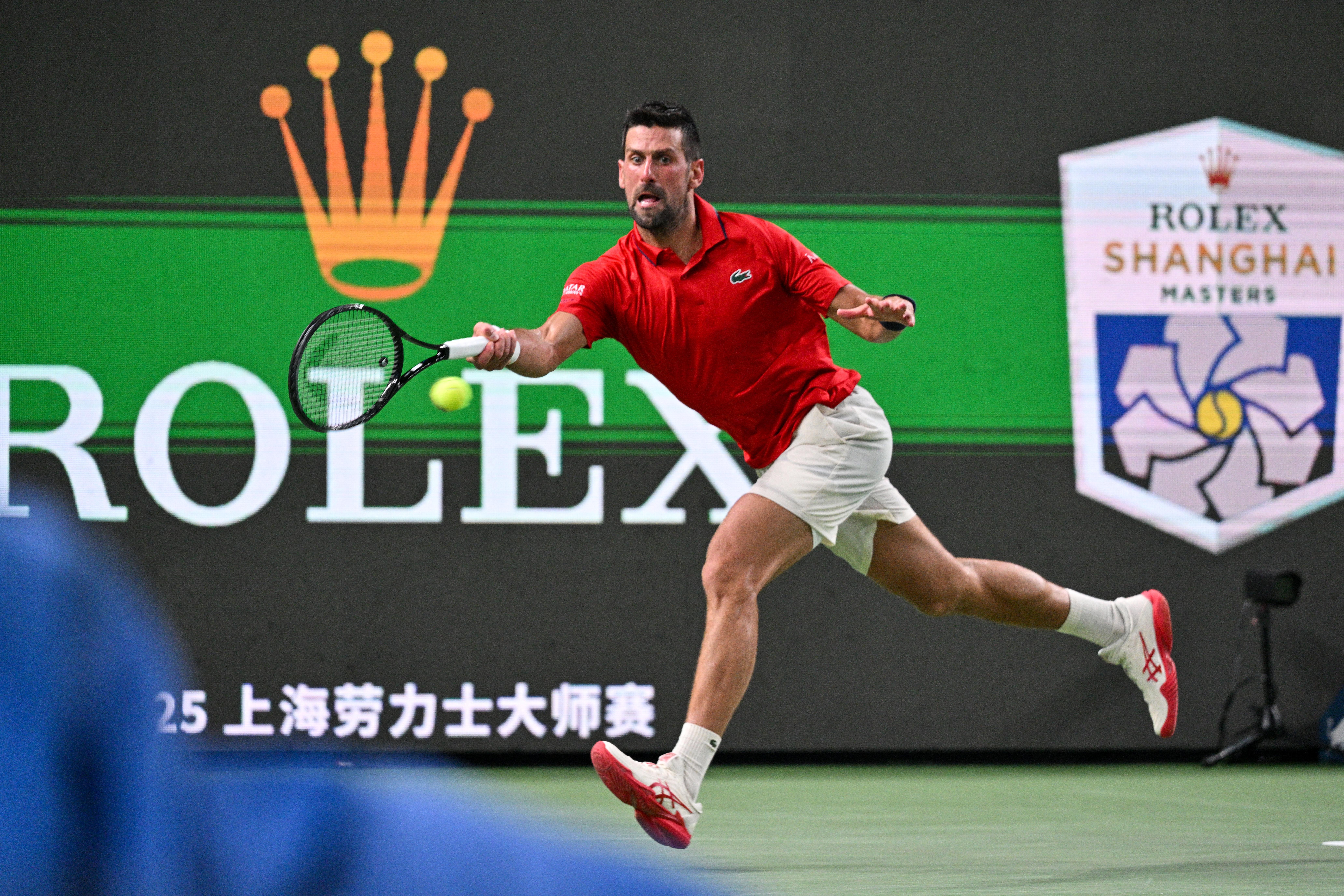 Serbia's Novak Djokovic hits a return to Spain's Jaume Munar during their men's singles match at the Shanghai Masters tennis tournament in Shanghai on October 7, 2025. (Photo by Hector RETAMAL / AFP)