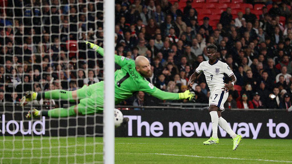 England's Bukayo Saka scores his team's first goal past Serbia's Predrag Rajkovic