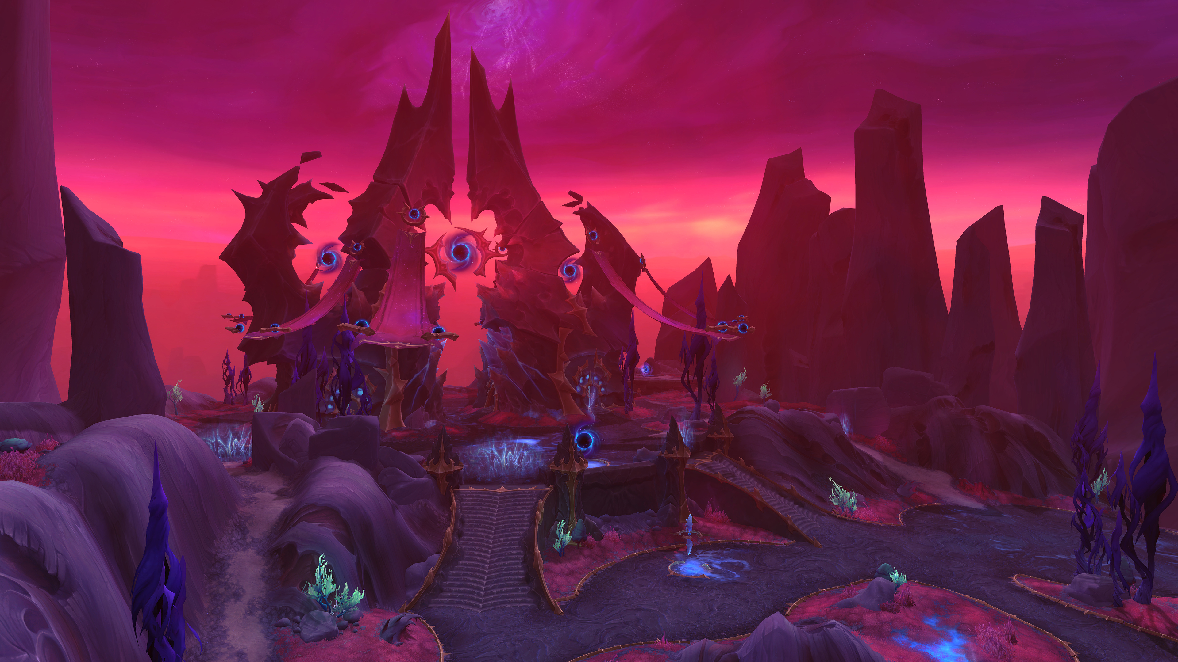 A promotional screenshot of the World of Warcraft: Midnight alpha. A wide shot of a dark red location. Many paths lead up toward a central location with jagged architecture reaching into the crimson sky.