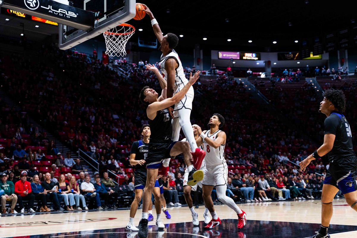 San Diego State forward Jeremiah Oden (25) dunks over Whittier center Bernardo Zappia (25) during an NCAA Basketball game between Whittier and San Diego State, Monday December 22, 2025 at Viejas Arena in San Diego, Calif.