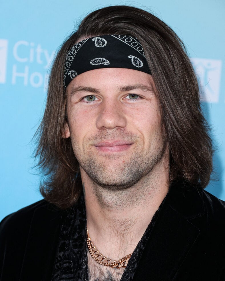 Caleb Shomo posing on the red carpet.