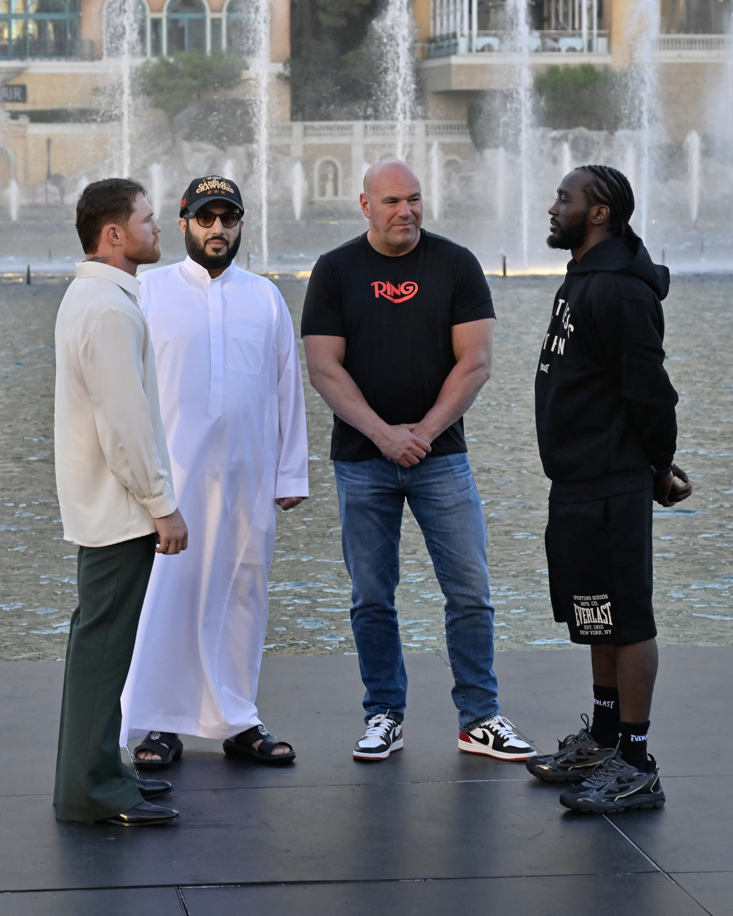LAS VEGAS, NEVADA - SEPTEMBER 08: Canelo Alvarez (L) and Terence Crawford (R) face off as Turki Al-Sheikh (2nd from L) and Dana White look on during Netflix's Canelo vs Crawford Faceoff at The Fountains of Bellagio on September 08, 2025 in Las Vegas, Nevada. David Becker/Getty Images for Netflix/AFP (Photo by David Becker / GETTY IMAGES NORTH AMERICA / Getty Images via AFP)