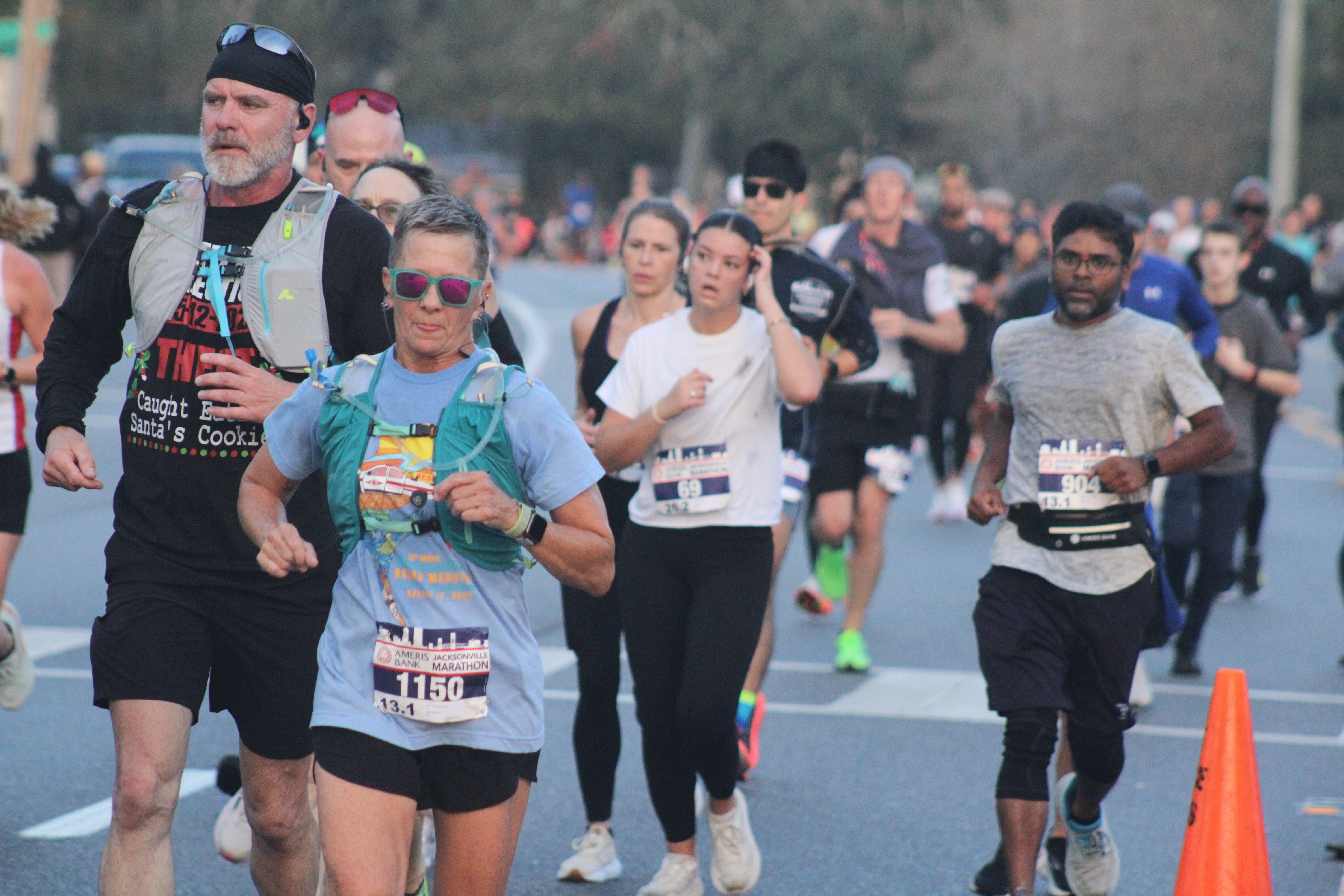 Dozens of runners make their way down San Jose Boulevard for the Ameris Bank Jacksonville Marathon on Dec. 14, 2024. [Clayton Freeman/Florida Times-Union]