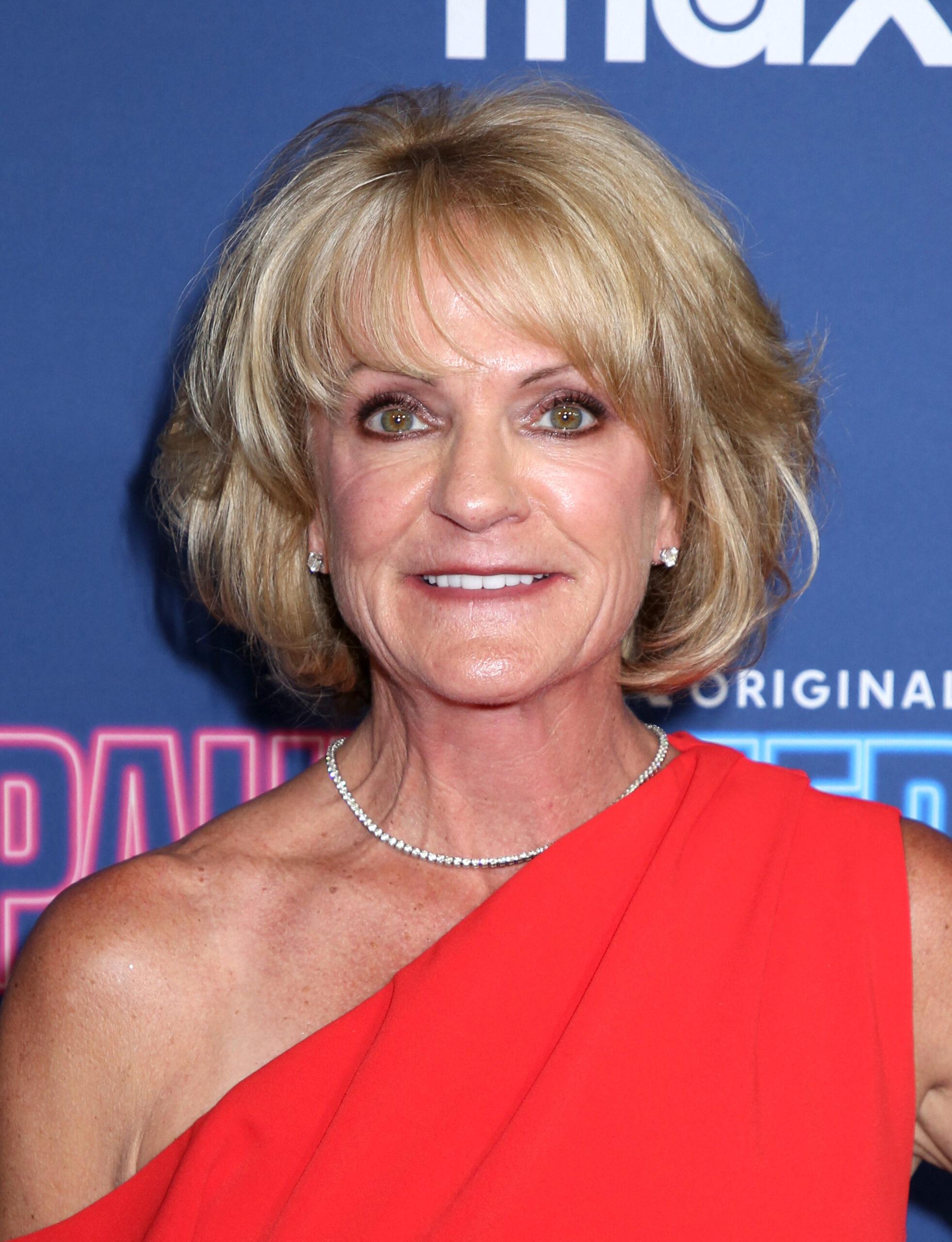 Logan and Jake Paul's mom posing on the red carpet. 